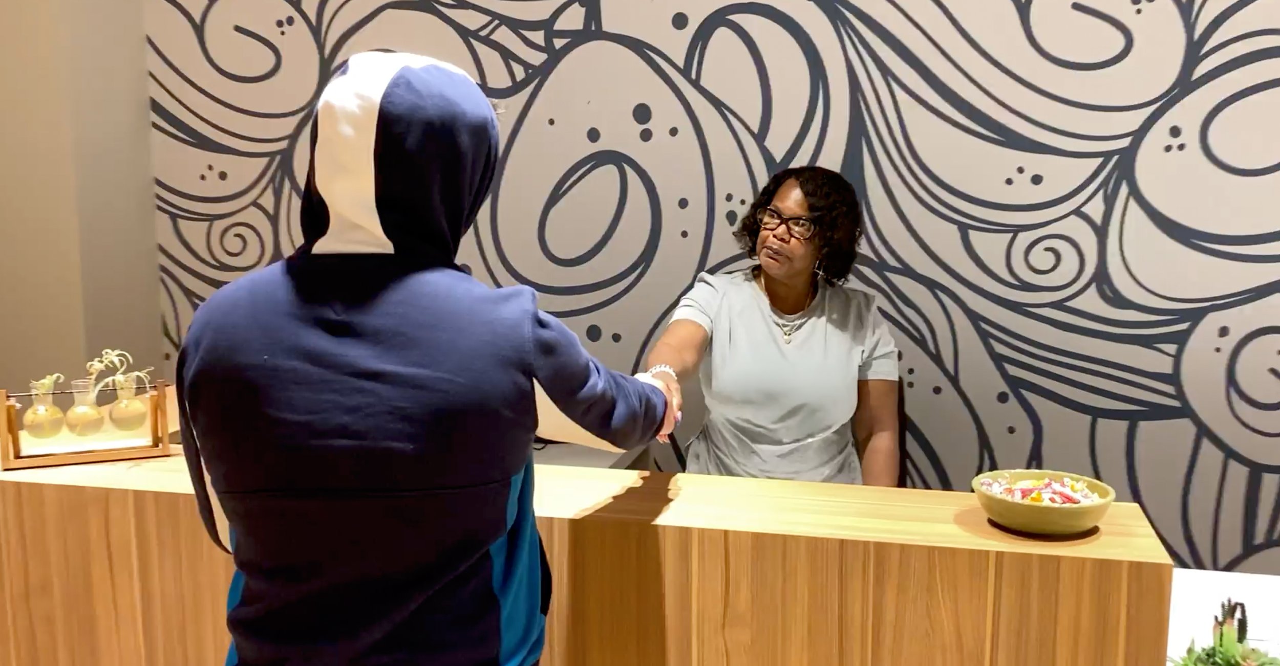 Image of a potential new resident at Weingart Tower being welcomed by a staff member