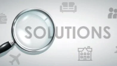 Magnifying glass highlighting the word 'SOLUTIONS' on a blurred background with icons related to travel, home, and communication.