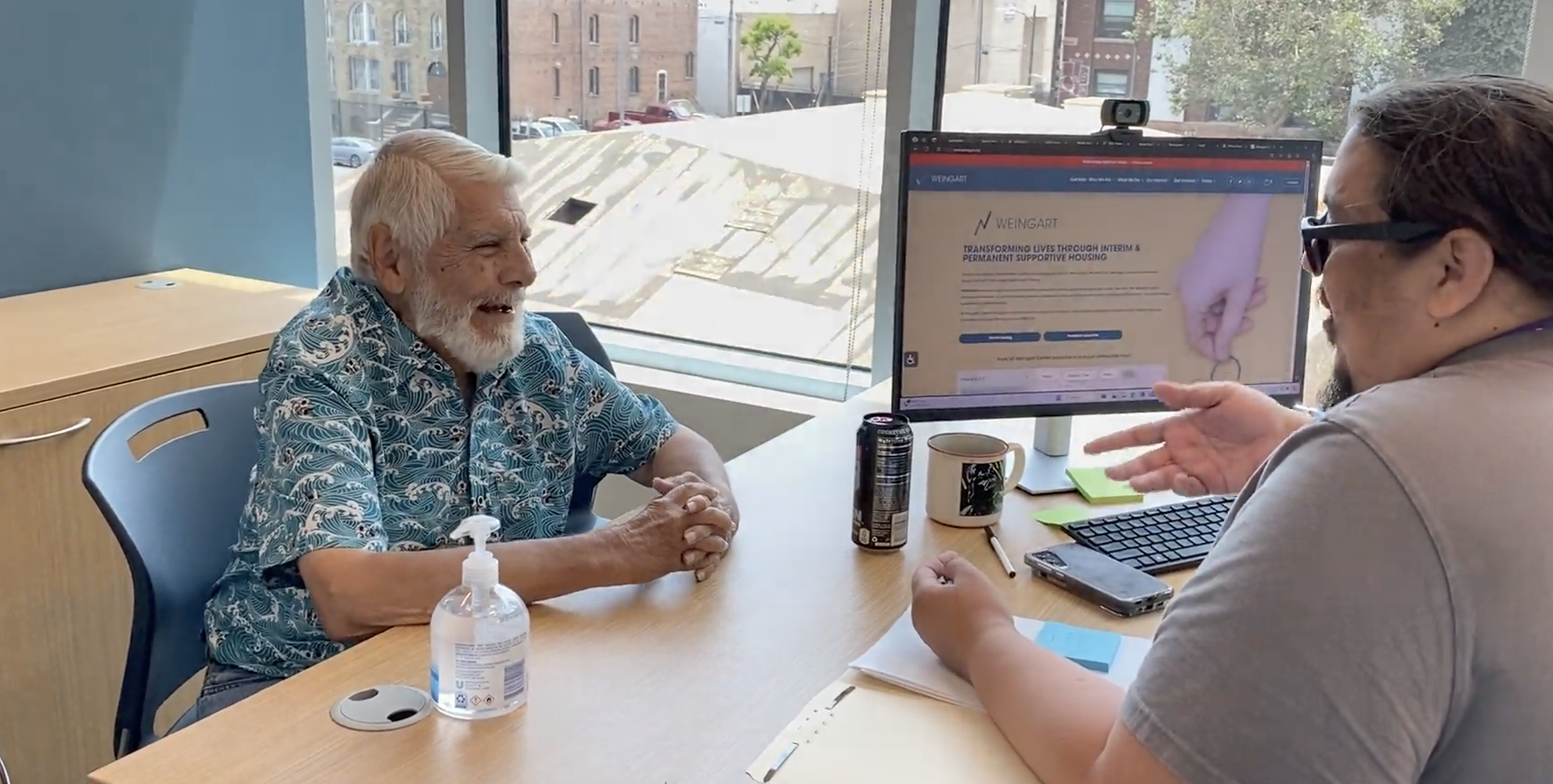 a photo of a Weingart Center resident meeting with his Resident Service Coordinator