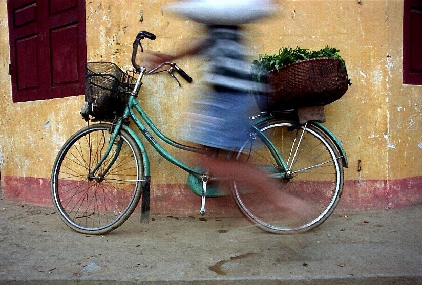 vietnam:man walks by bike.jpg