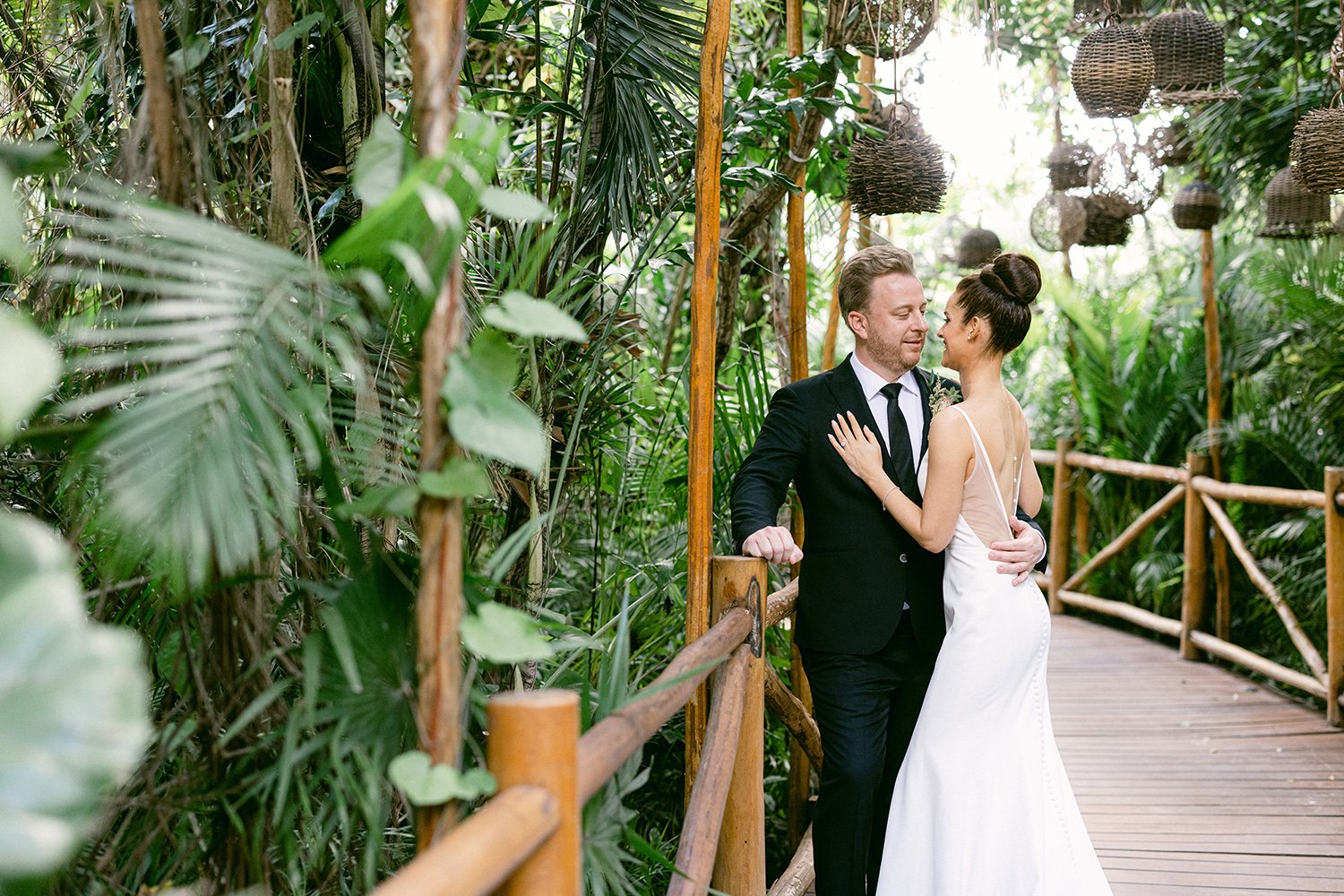 13 bride and groom smiling looking at each other hugging before their first look surrounded by green tropical plants at Rosewood Mayakoba Riviera Maya Cancun Mexico.JPG