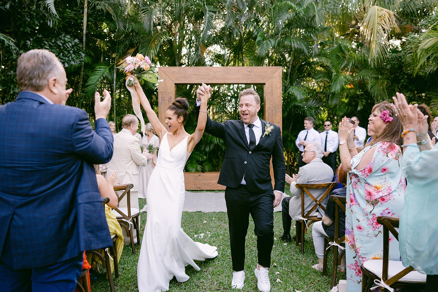 29 happy just married bride and groom smiling and wedding guests throwing petals at Rosewood Mayakoba Riviera Maya Cancun.JPG