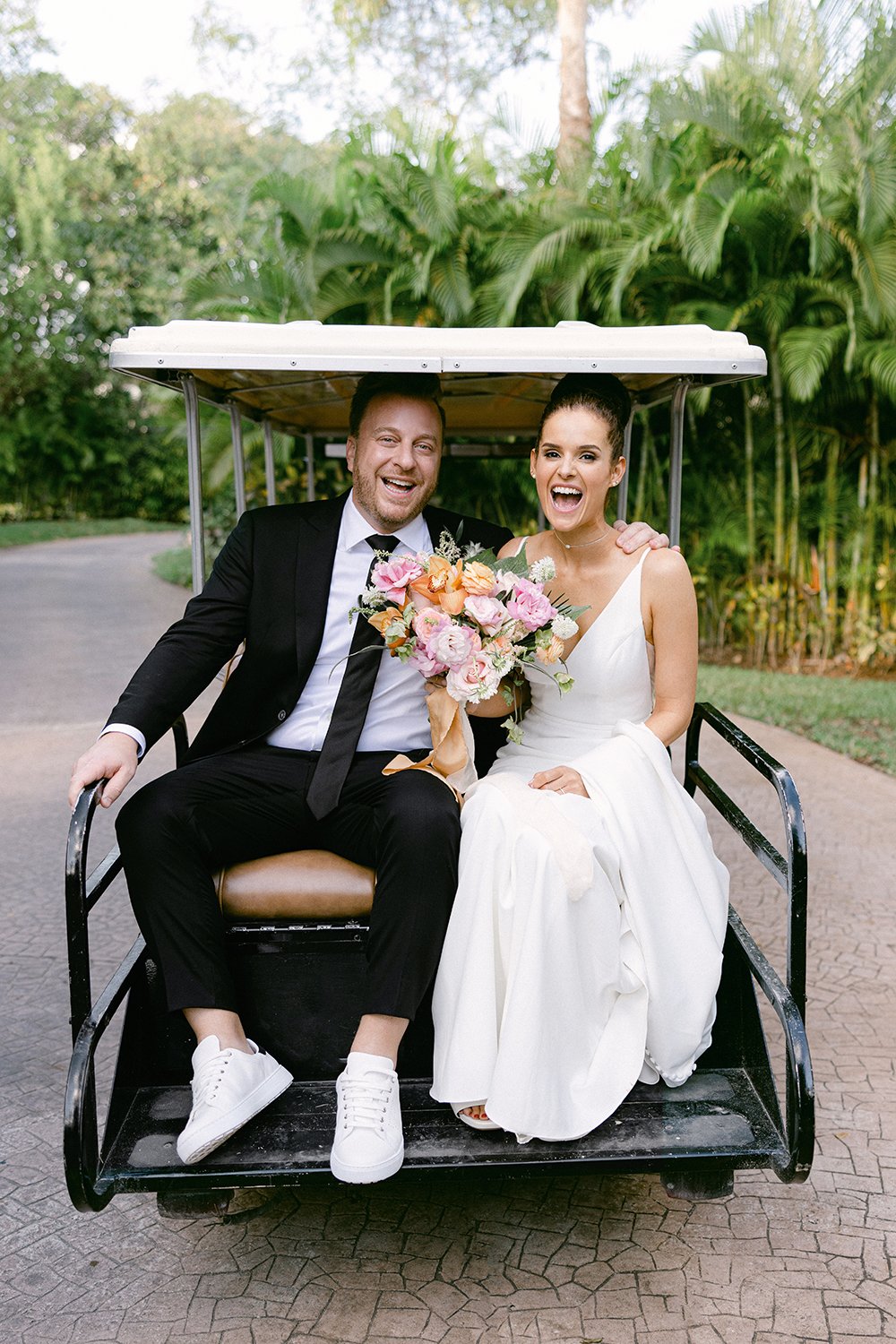 30 joyful smiling bride and groom hopped on a car after wedding ceremony at Rosewood Mayakoba Riviera Maya Cancun.JPG