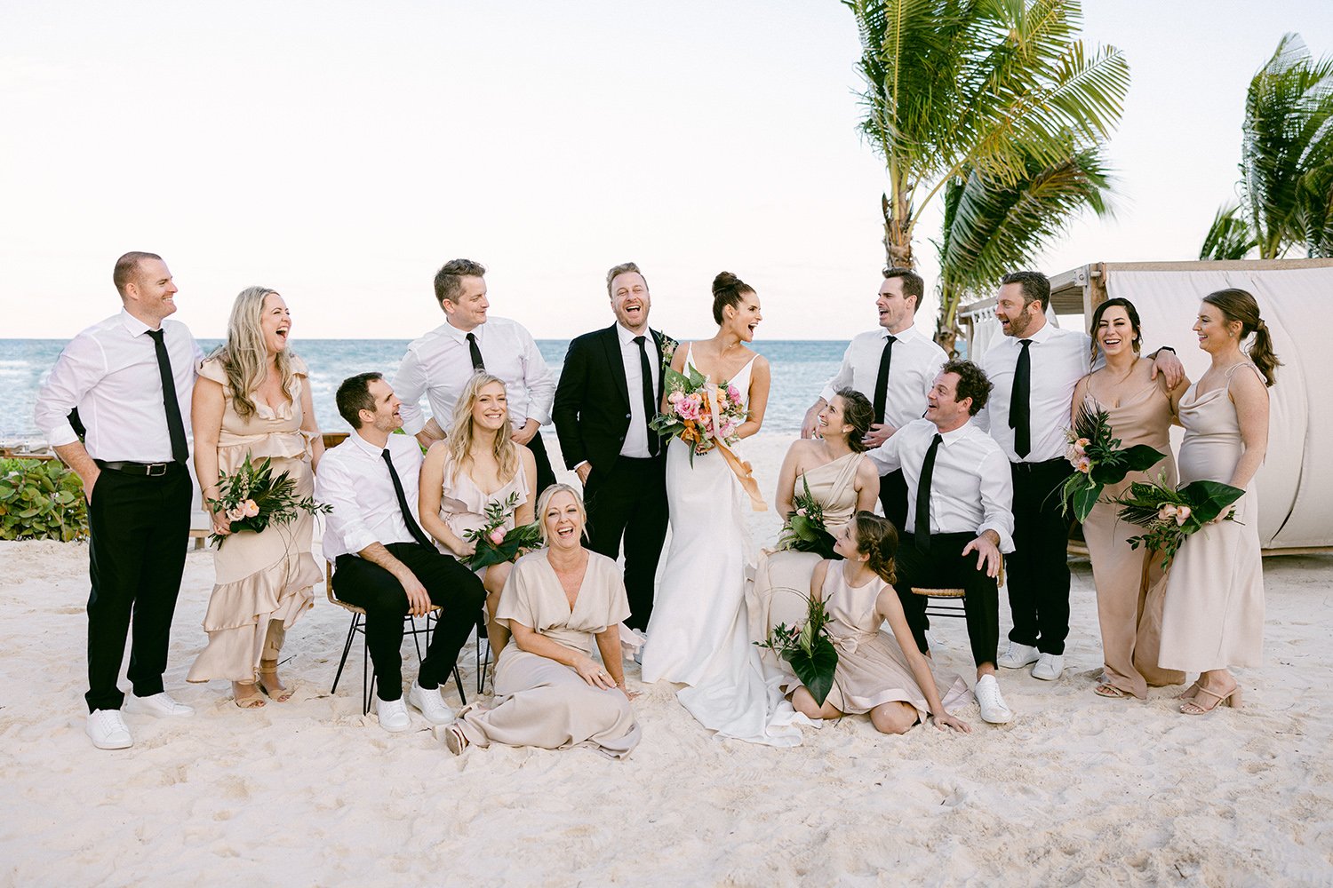 38 happy bridal party session having fun, bride and groom love on the beach with the sea behind at Rosewood Mayakoba Riviera Maya Cancun Mexico.JPG