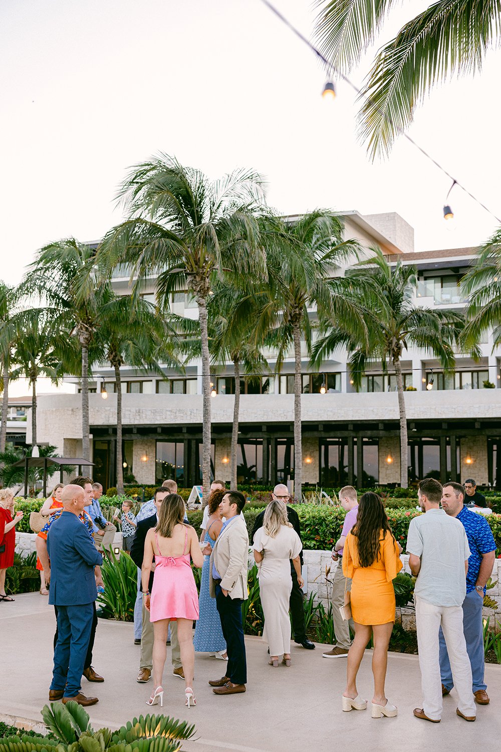 11 photography of rehearsal dinner's guests gathering around the cocktal hour enjoying conversations with others at Dreams Riviera Cancun.JPG