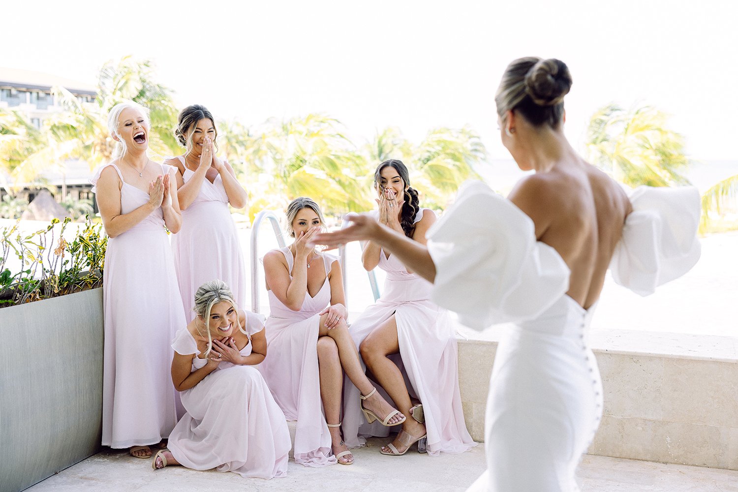21 wonderful first look reaction of bridesmaids looking at bride wearing her white wedding dress at Dreams Riviera Cancun.JPG