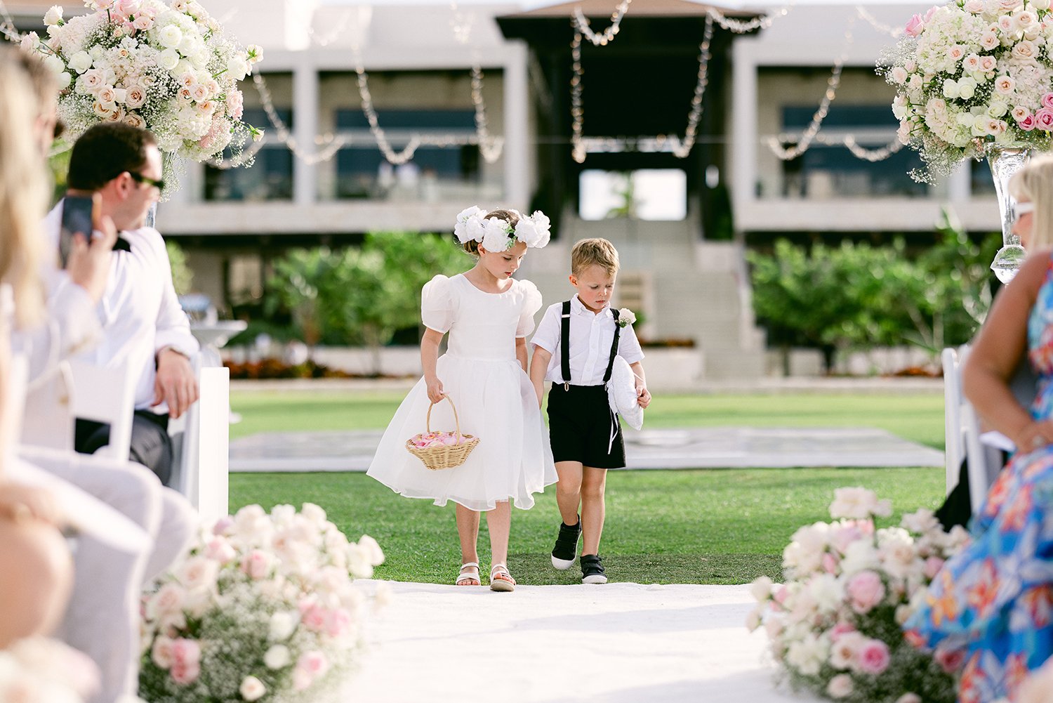 33 cute flower girl and ring bearer walking across wedding ceremony at Dreams Riviera Cancun.JPG