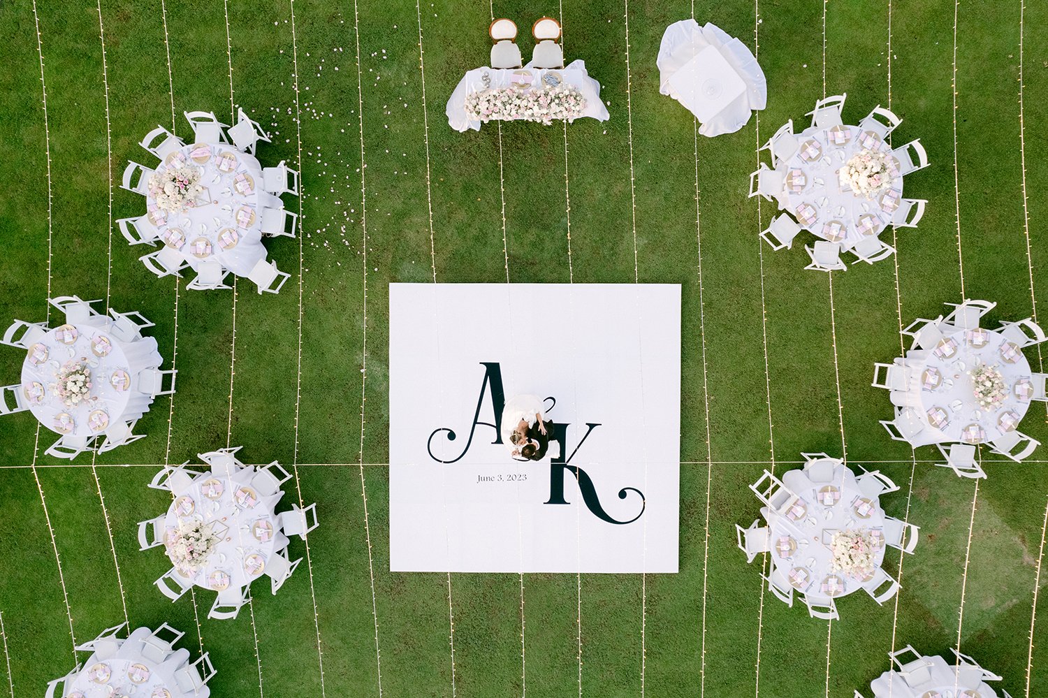 43 personalized wedding dance floor with bride and groom dancing over it with reception decoration all around over grass at Dreams Riviera Cancun.JPG