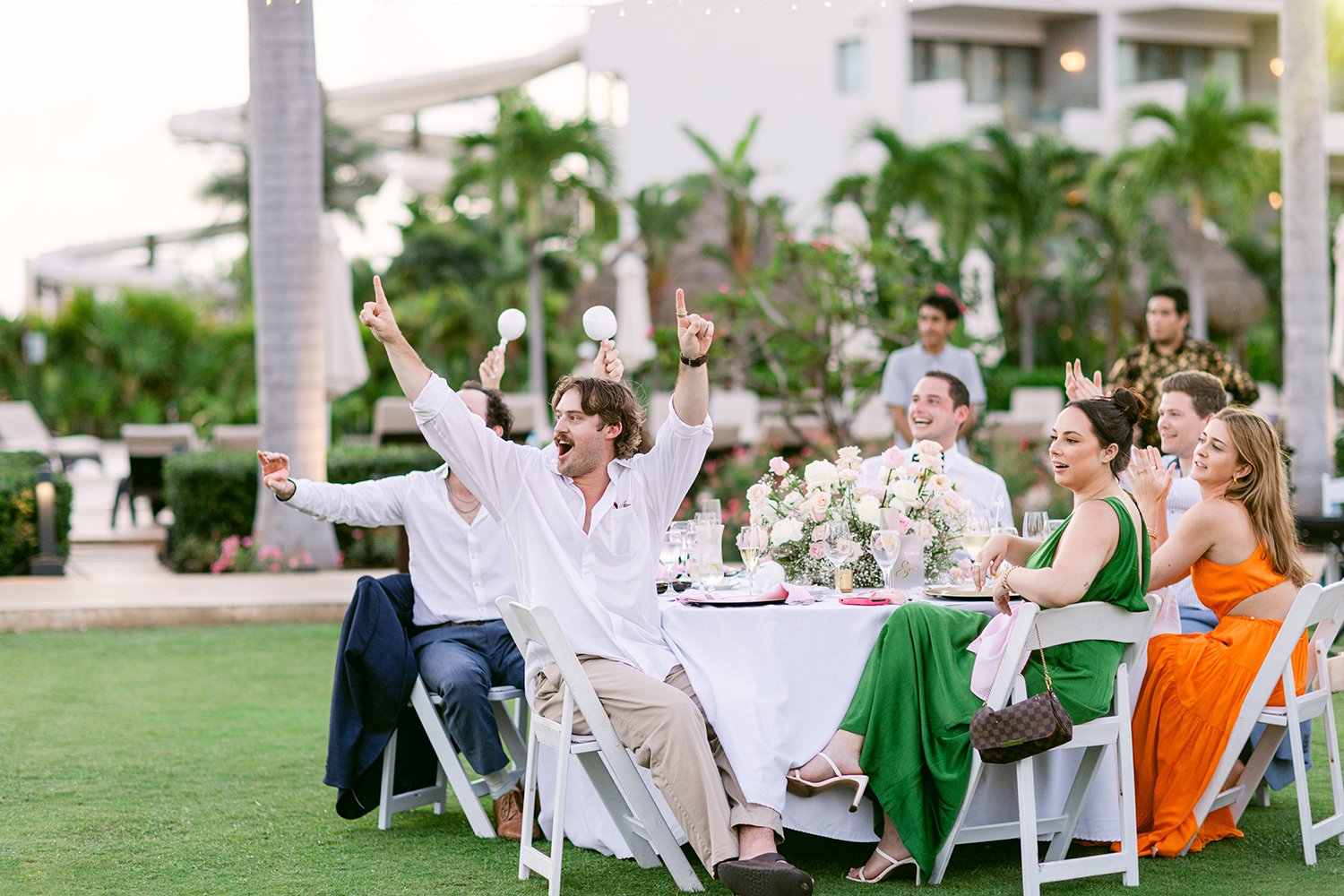 52 happy cheering weeding guests ccelebrating bride and groom grand entrance at Dreams Riviera Cancun.JPG