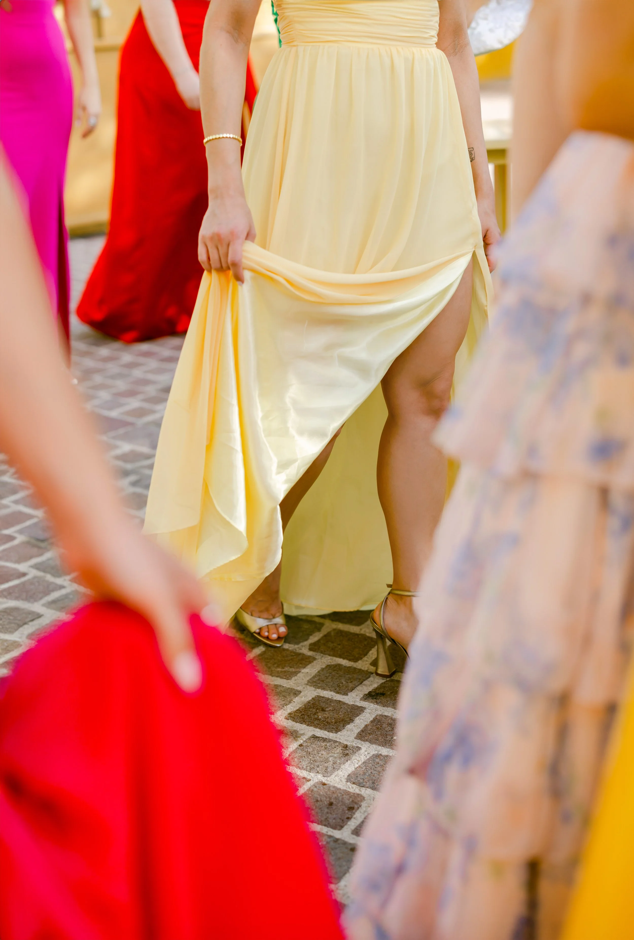 13 Beautiful shot of bridesmaids walking wearing lovely colorful dresses at Banyan Tree Mayakoba Riviera Maya.jpg