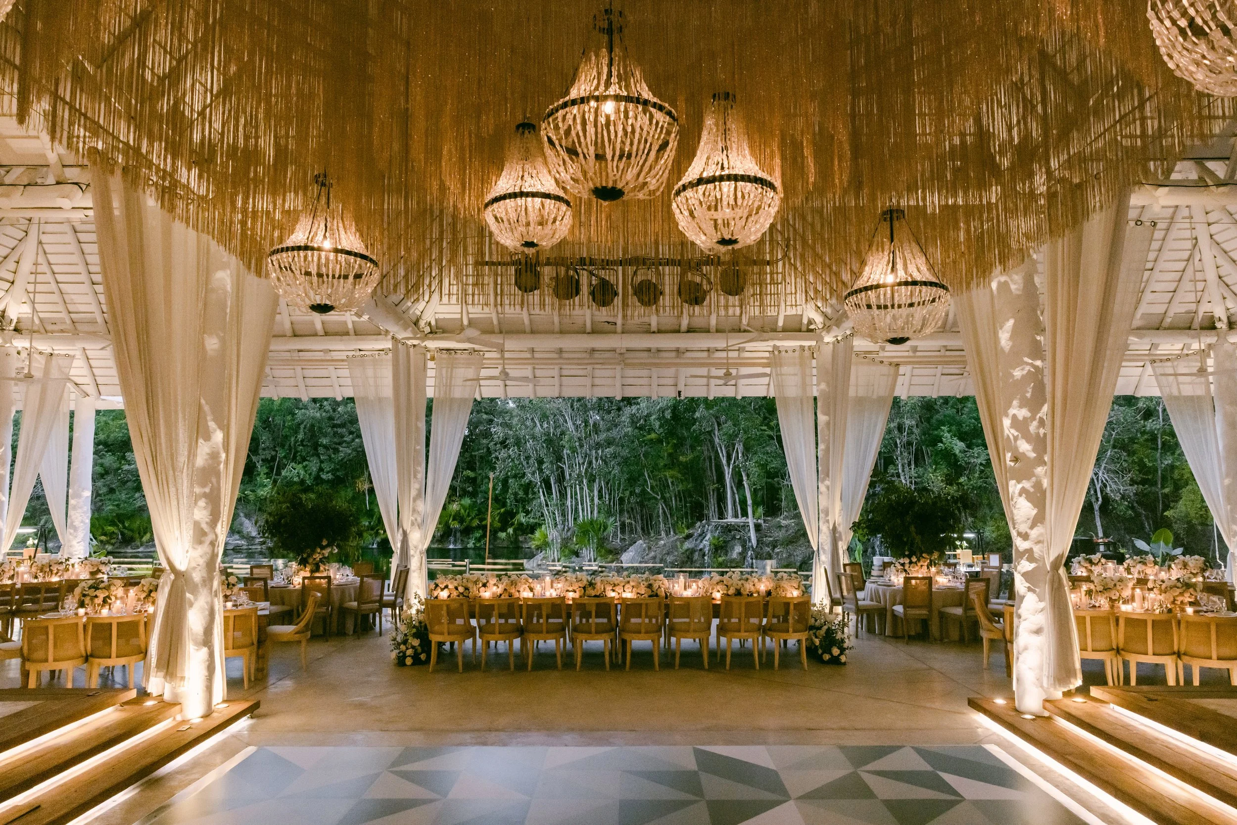 39 Night decoration of wedding reception tables set up with lighten chandeliers at Banyan tree Mayakoba Riviera Maya.jpg