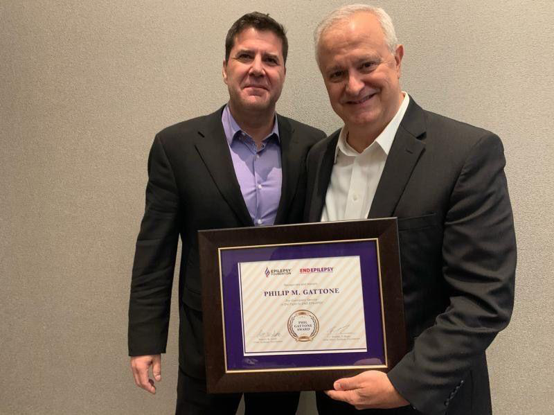  Epilepsy Foundation Board President, Brad Boyer, presents Phil with the first  “Phil Gattone Award for Exemplary Service”  to recognize Phil’s lifetime of significant achievements.  