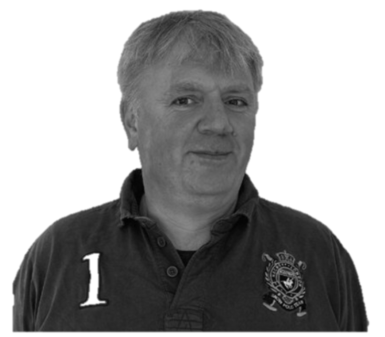 Black and white portrait of a middle-aged man wearing a dark polo shirt with the number '1' and a badge on it.