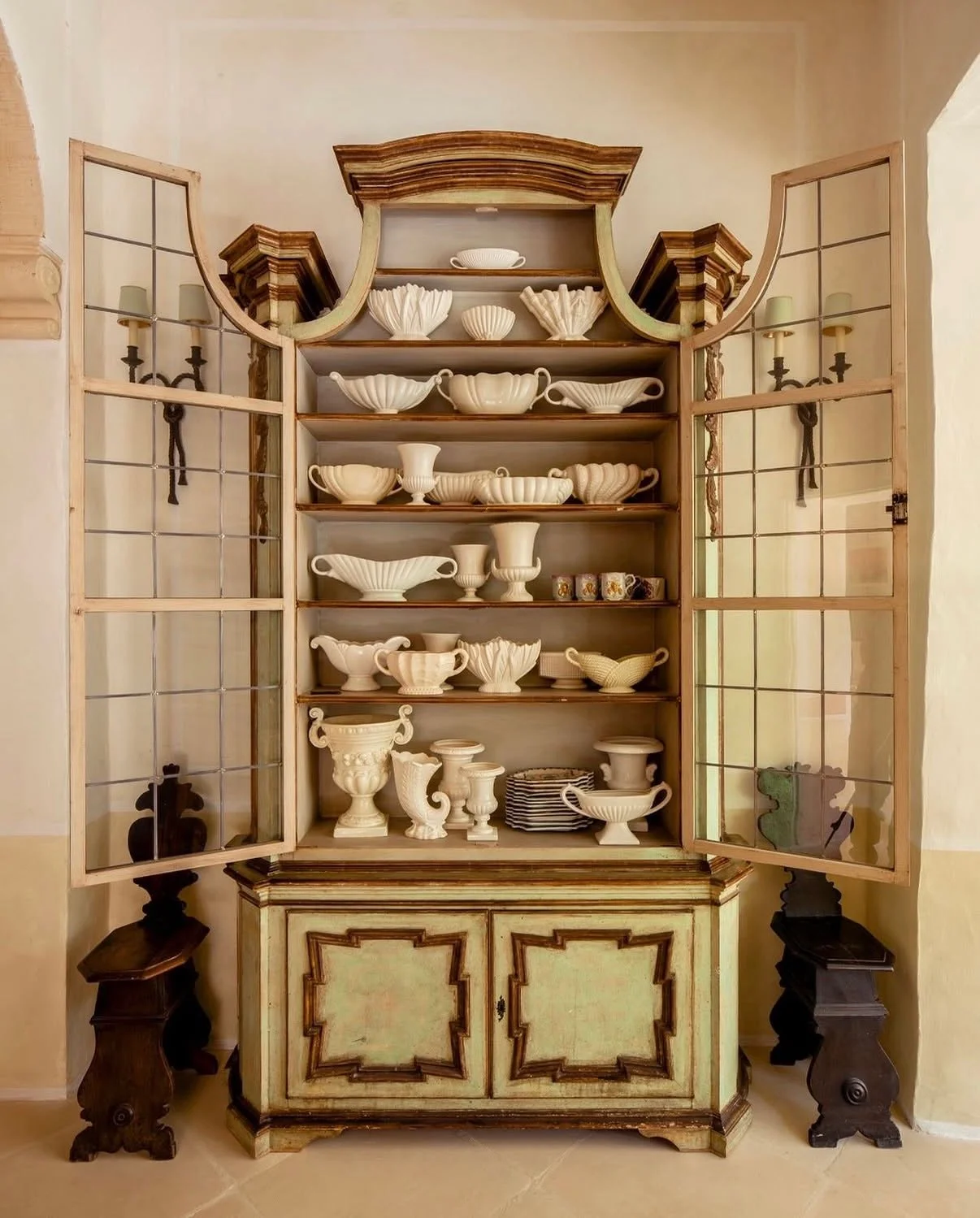 A collection of vessels in a decorative cabinet in Casa Bonavita. 