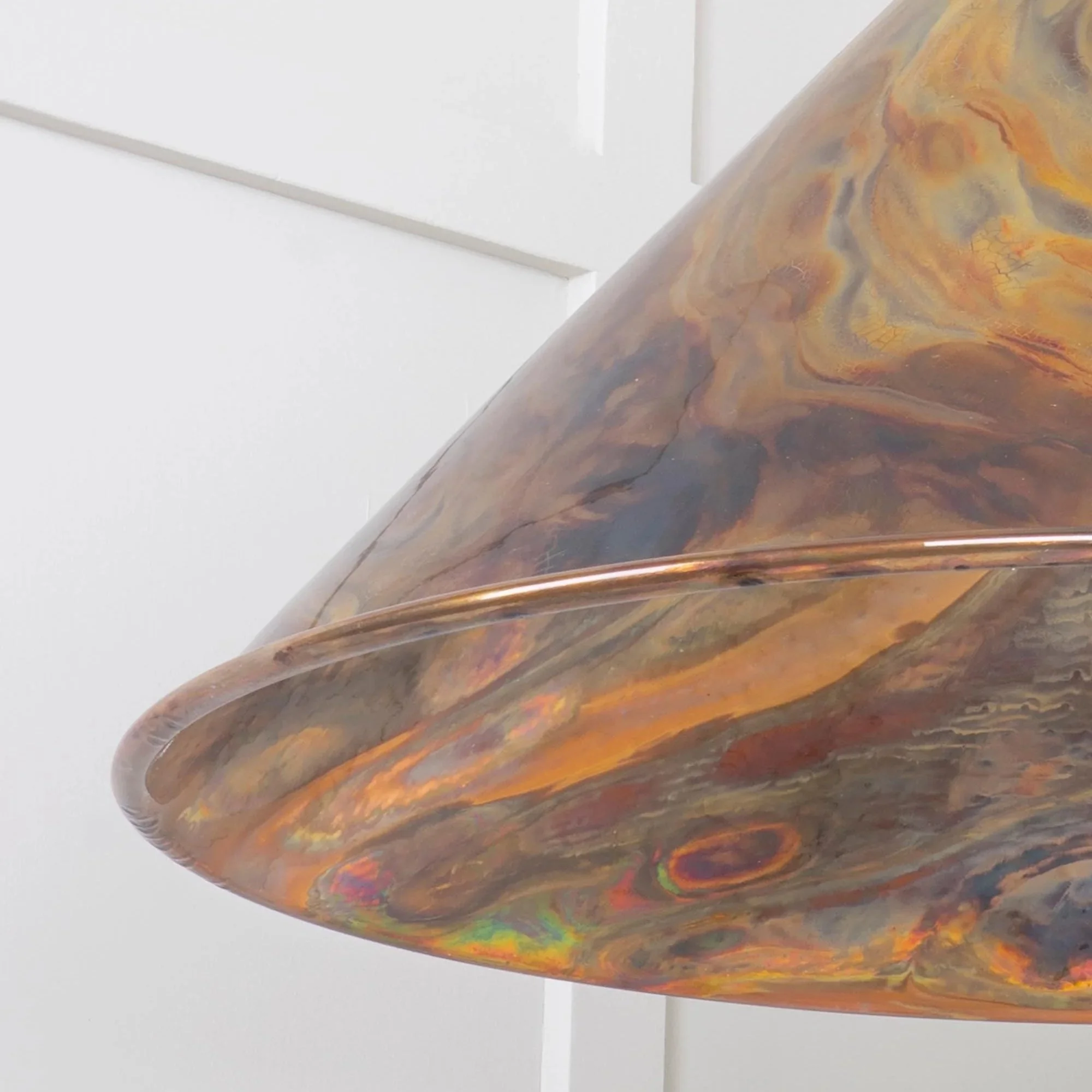 Close-up of the Hawthorne burnished pendant lamp highlighting hand-applied layers of colour and texture