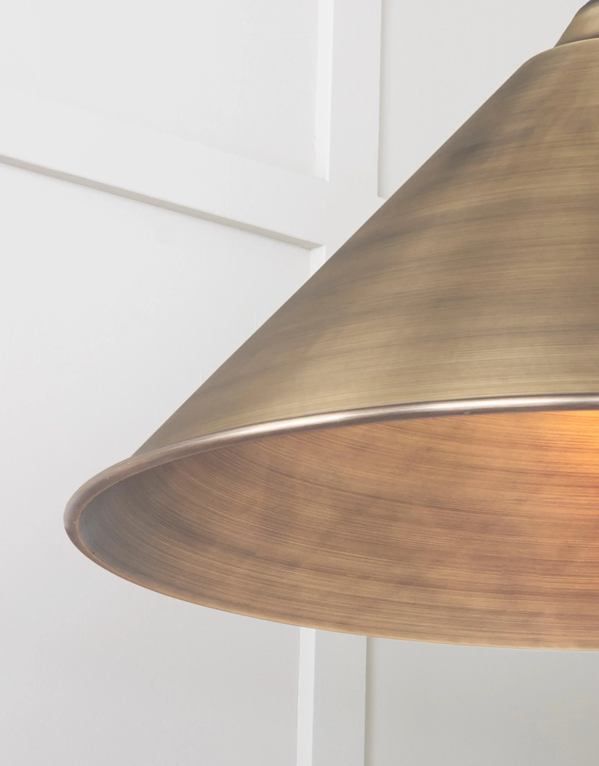 Close-up of the Hawthorne pendant lamp showing hand-aged matt brass finish and warm patina