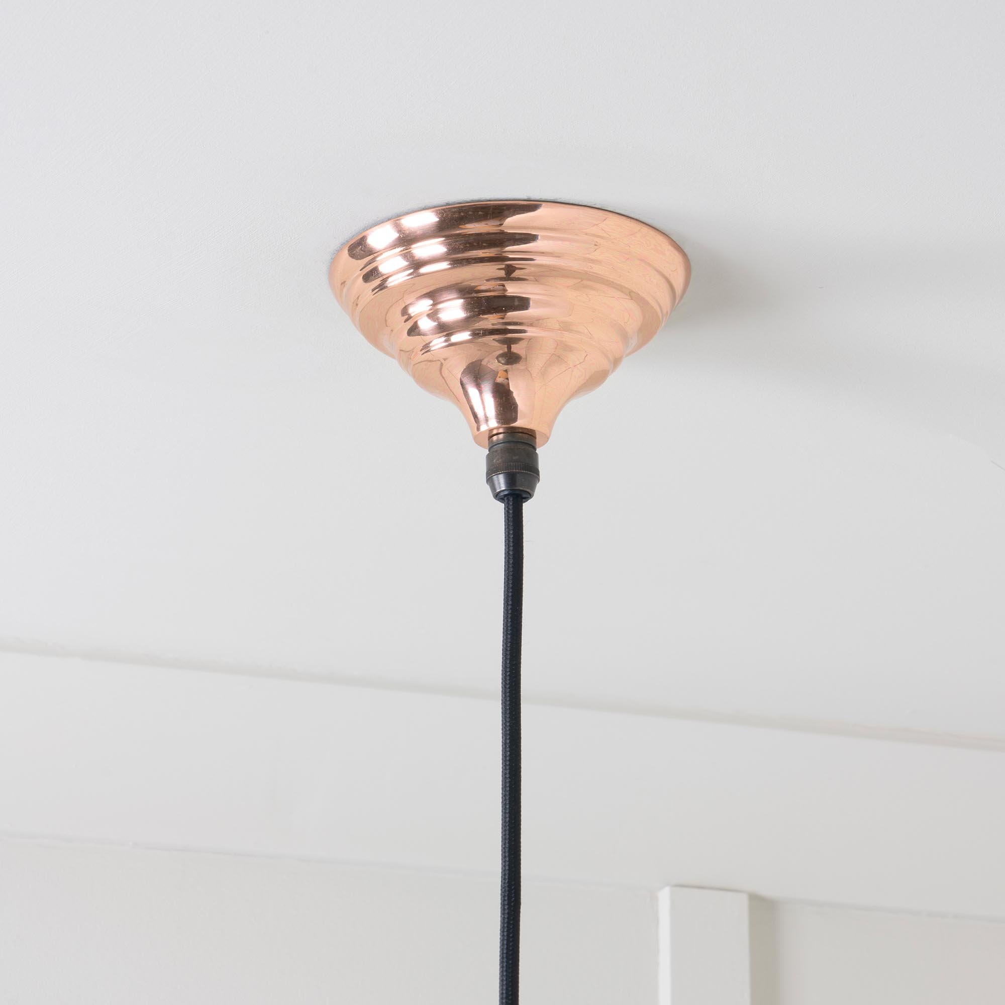Detail view of the Hawthorne pendant lamp, hand-spun from solid copper and polished by hand