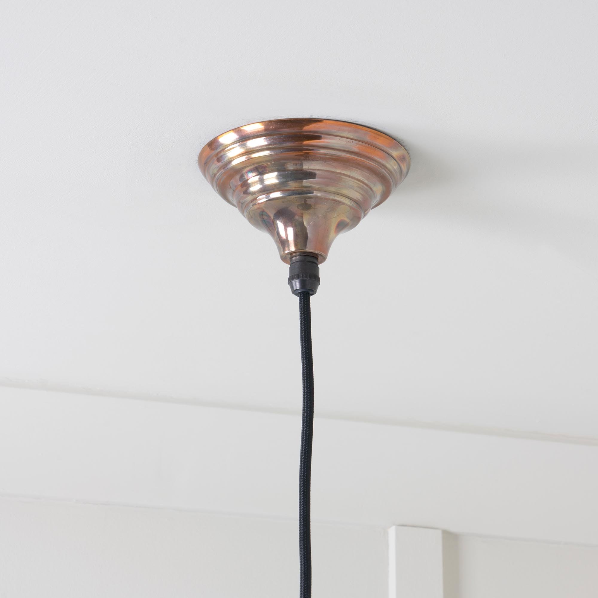 Detail view of Hawthorne pendant lamp with exclusive burnished finishing technique, hand-crafted layers visible.