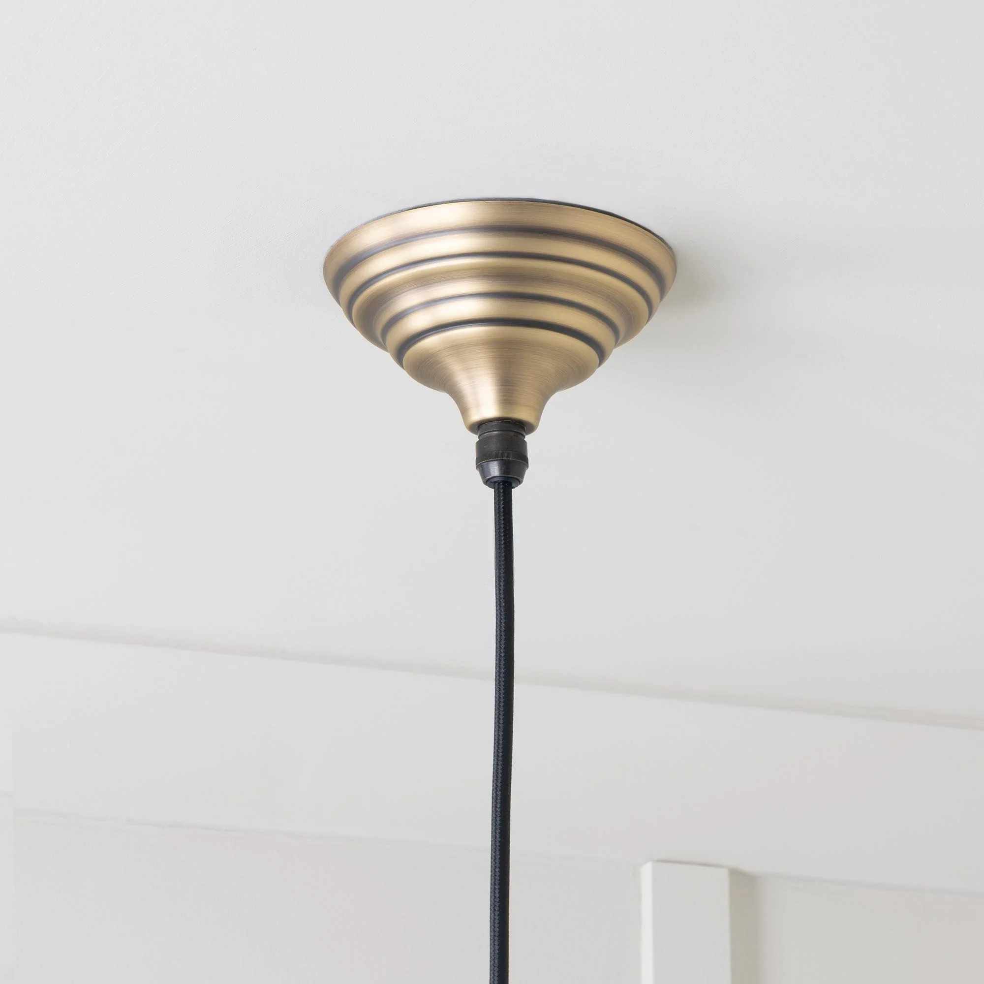 Hawthorne pendant light in aged brass, a bold statement lighting piece with warm tonal finish.