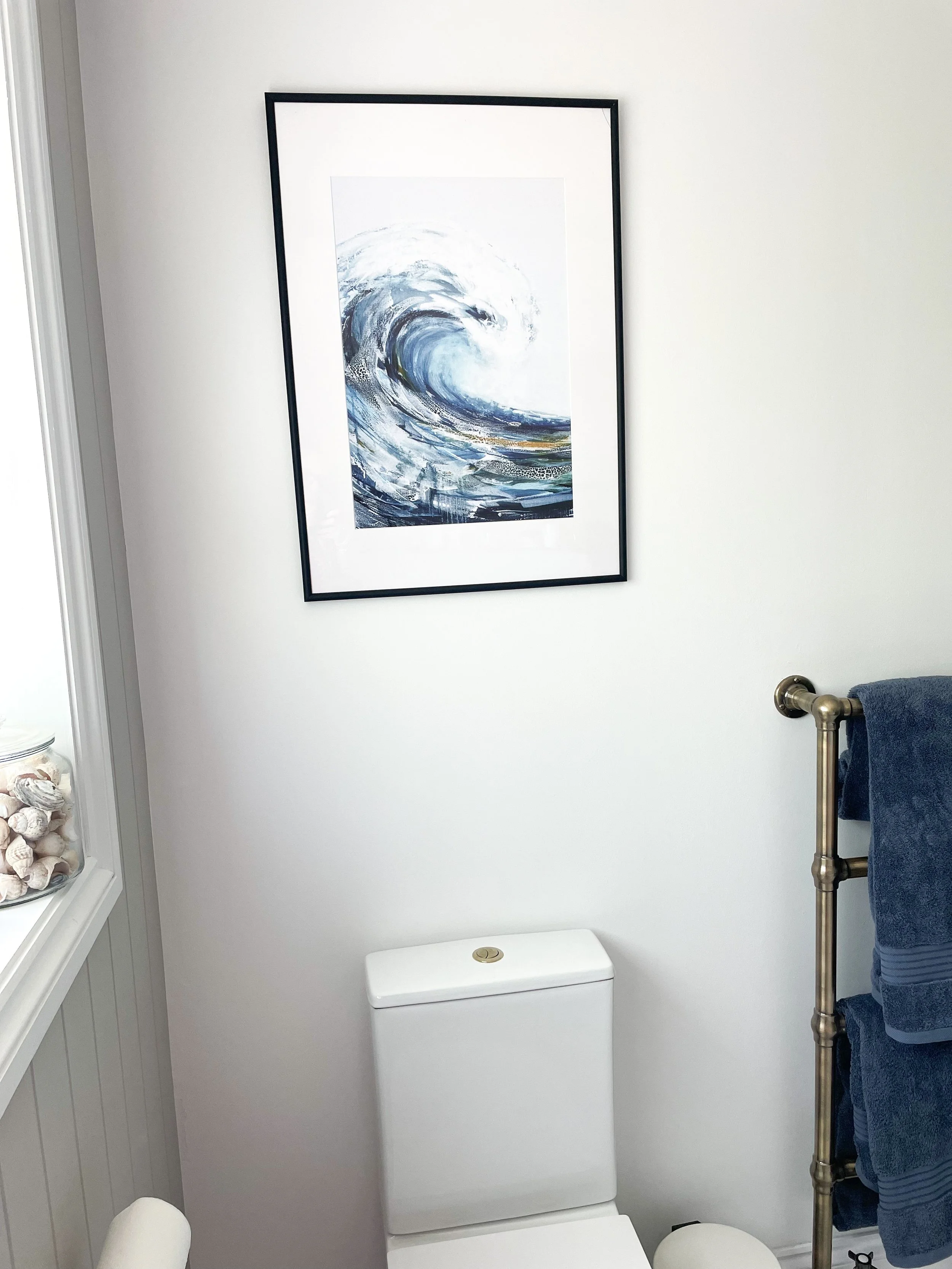 blue bathroom design with wave artwork in sussex