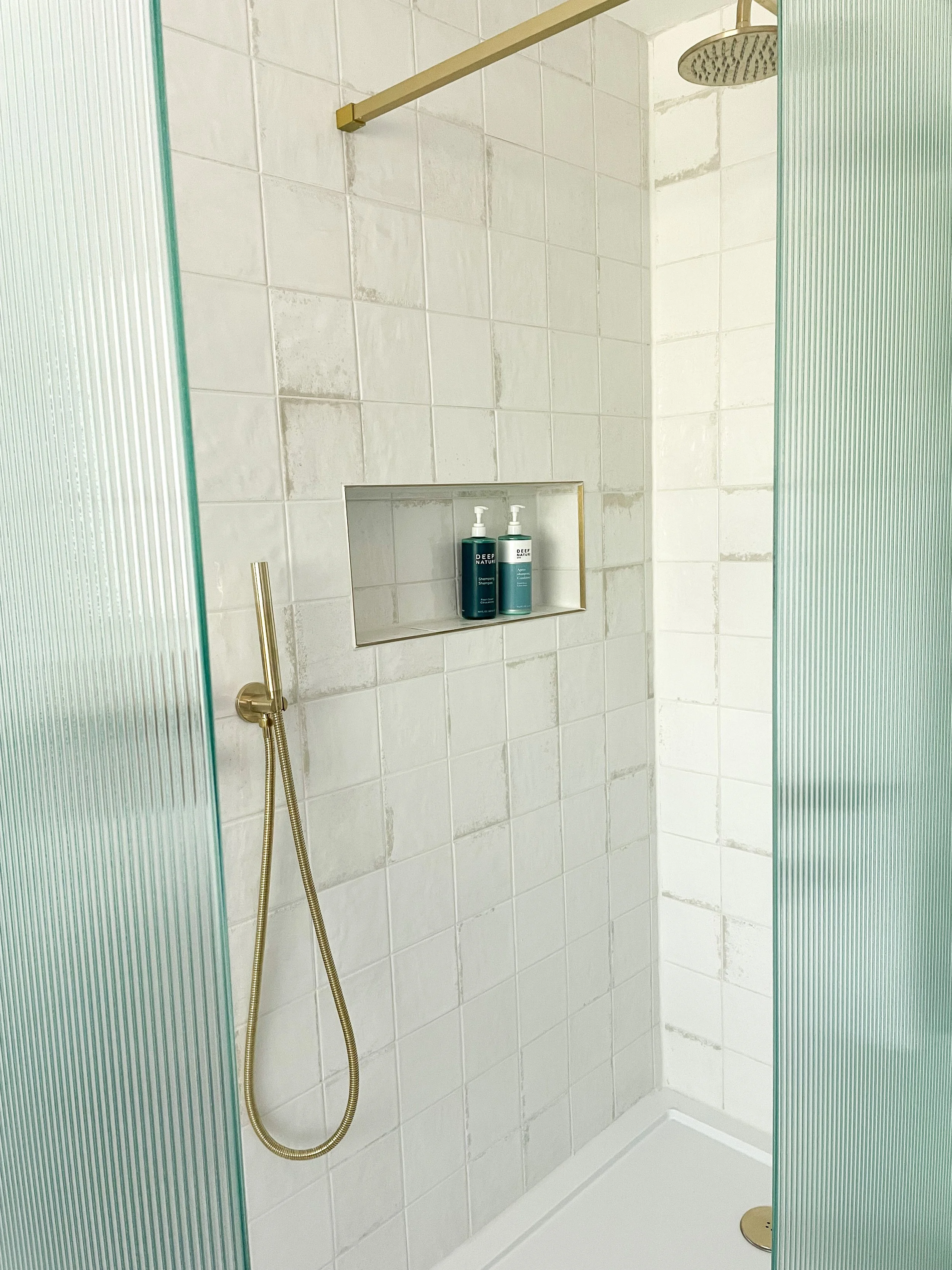 shower with fluted glass and gold accessories in sussex