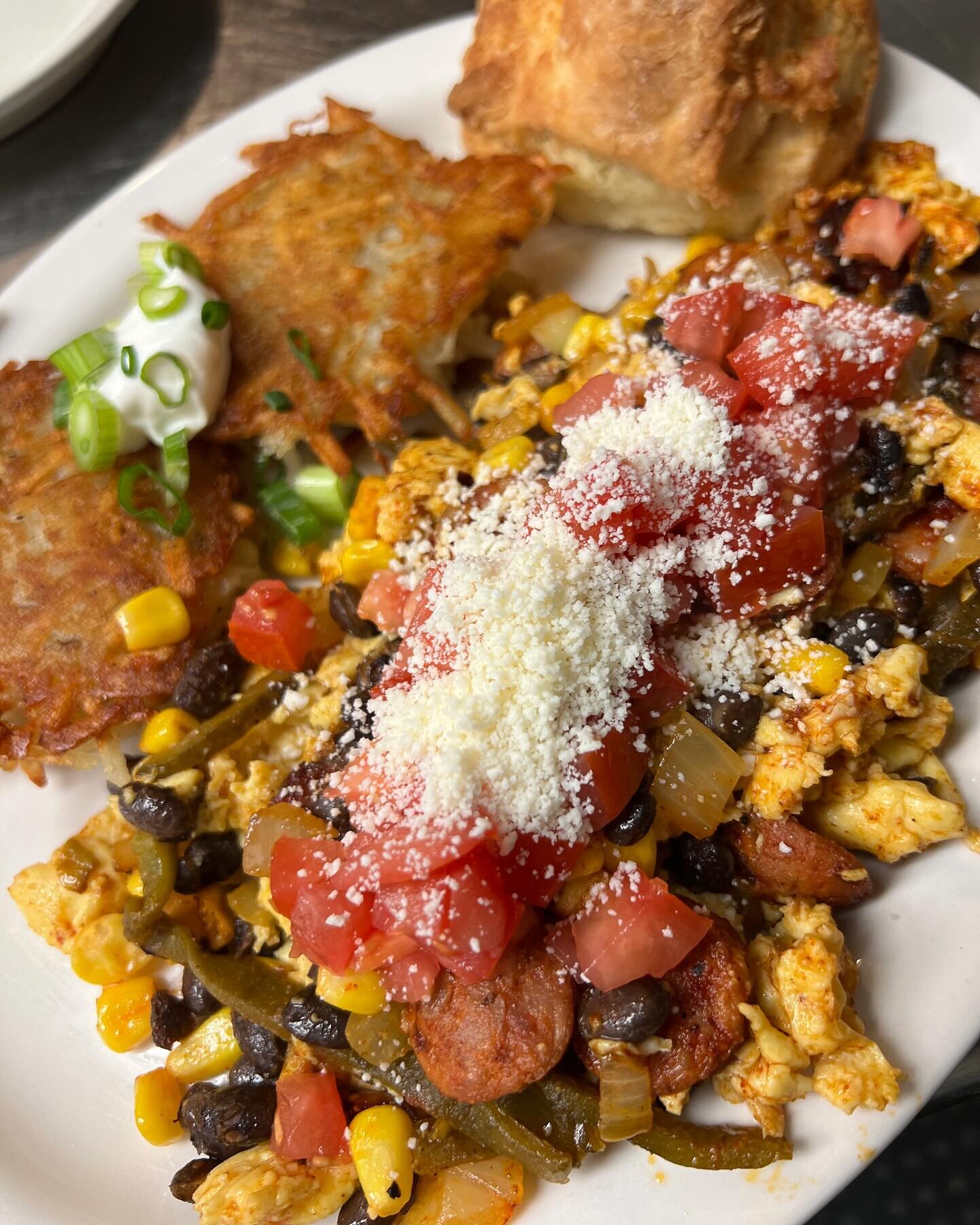 Come and get this delicious special while it lasts! We are serving up a two egg scramble with lingui&ccedil;a sausage, onion, corn, black beans and roasted poblano topped with cotija cheese and diced tomatoes, comes with a choice of potato cakes or c