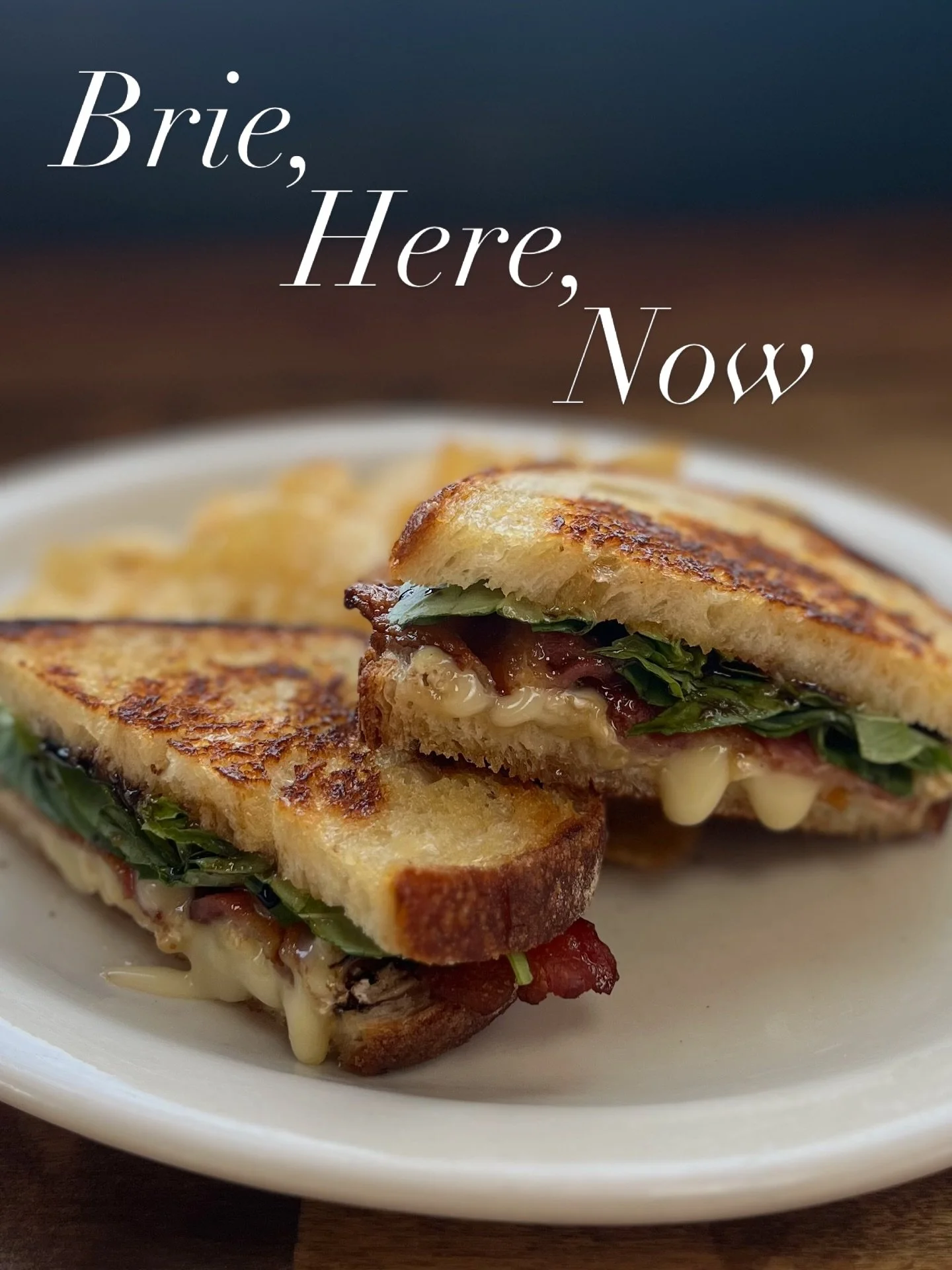 Brie, Here, Now. We are actually talking about melted Brie, apricot jam, hickory-smoked bacon, fresh basil, and balsamic reduction on buttered grilled sourdough. This is just one of the new offerings from our seasonal menu. So pop in, you&rsquo;ll be