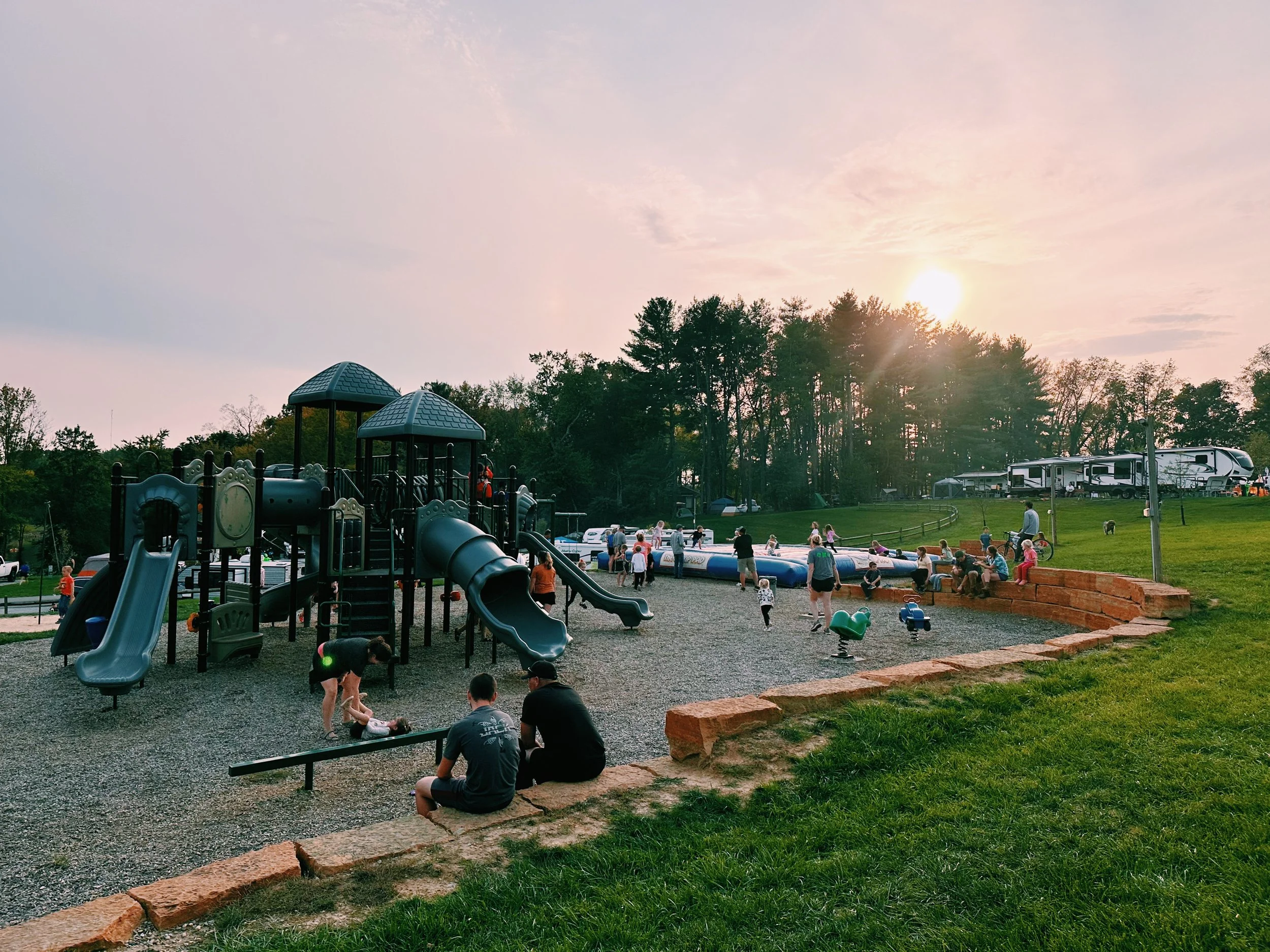 The playground at sunset. Many children playing.