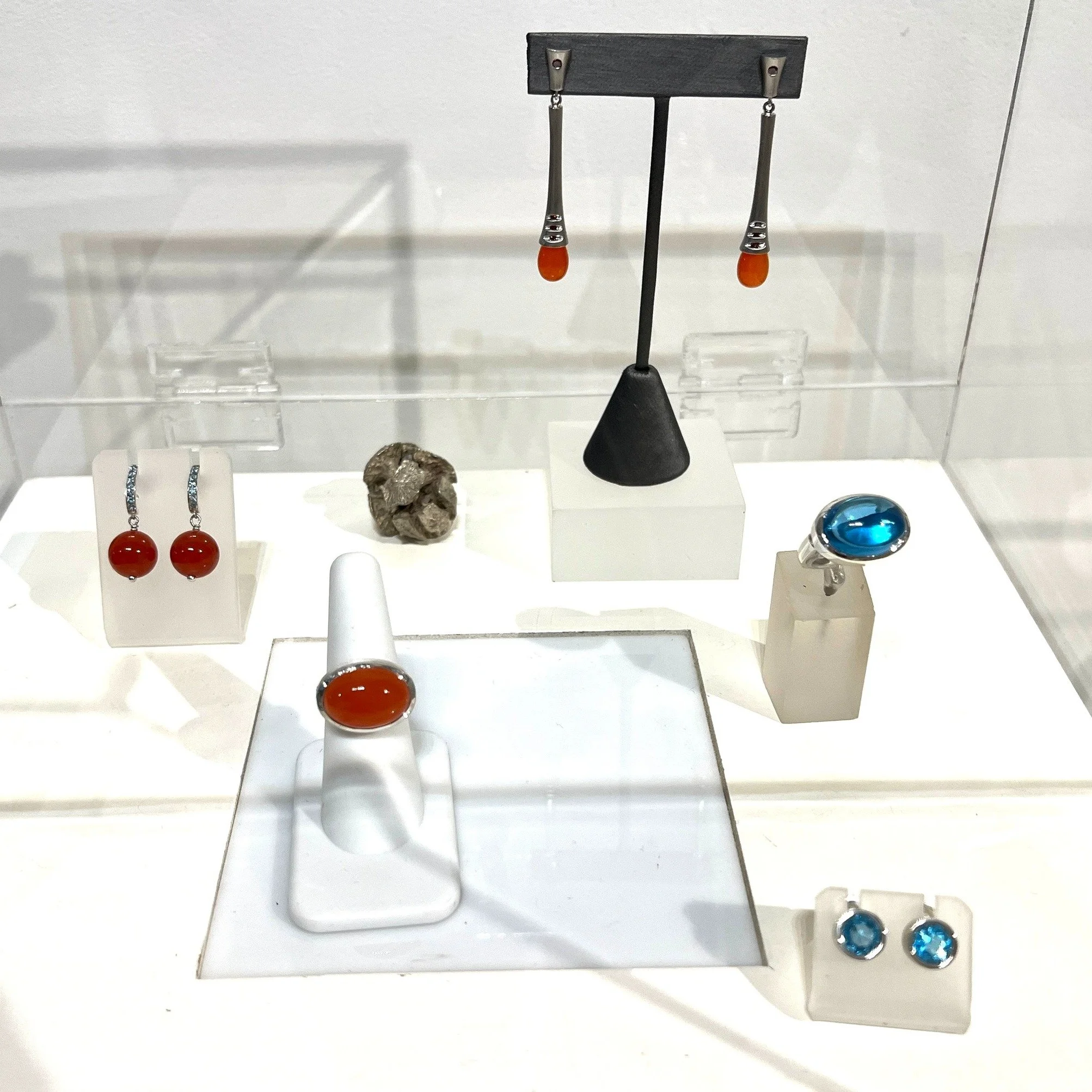 Thank you everyone who came and said hello at Artwalk!  Here are a few favorites. Carnelian and blue topaz combinations of blue and orangey red!  The oval cabochon rings are set in silver.  The dangle drops are in platinum with orange/red diamonds!  