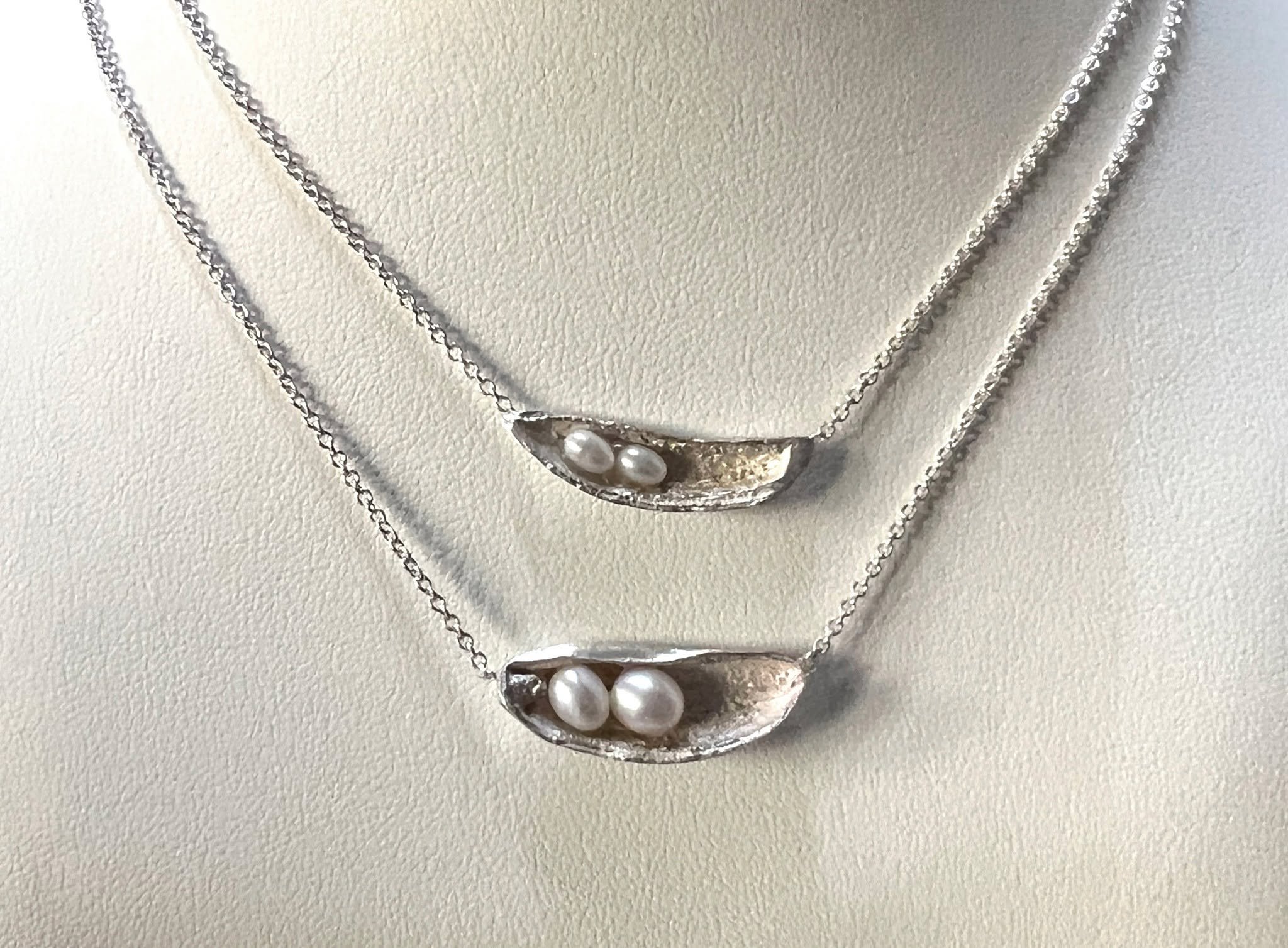 This is the newest edition to our Precious Objects Collection. I've had it on my jeweler's bench for a while.  These pods are cast in silver and nestle tiny fresh water pearls.  I am really liking them layered. 

#freshwaterpearljewelry  #freshwaterp