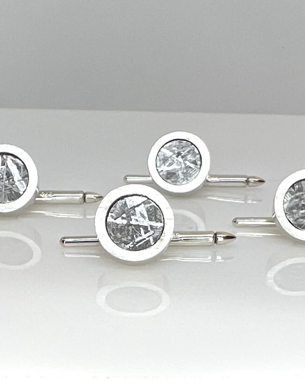 Meteorite set in sterling silver shirt studs. The Gibson meteorite has amazing striations of iron and nickel.  These studs match with a set of cufflinks I had previously made for this client.  #meteroriteshirtstuds #meteoritejewelry #customshirtstuds