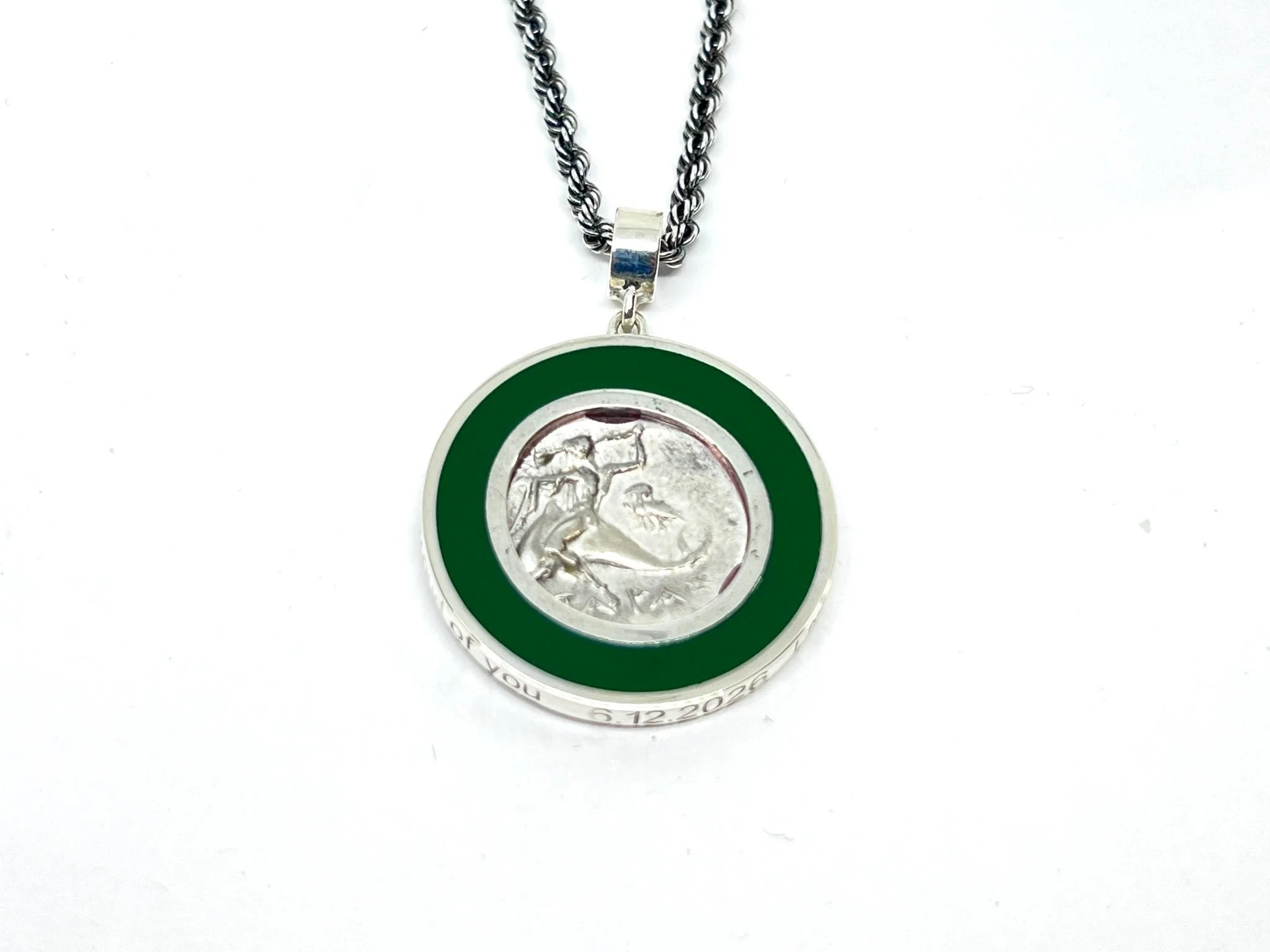 Taras Coin Pendant
A reversible custom graduation pendant for a young woman whose love of marine life, mythology, and the color green inspired the design. A coin depicting Taras, son of Poseidon, riding a dolphin to shore after a shipwreck became the