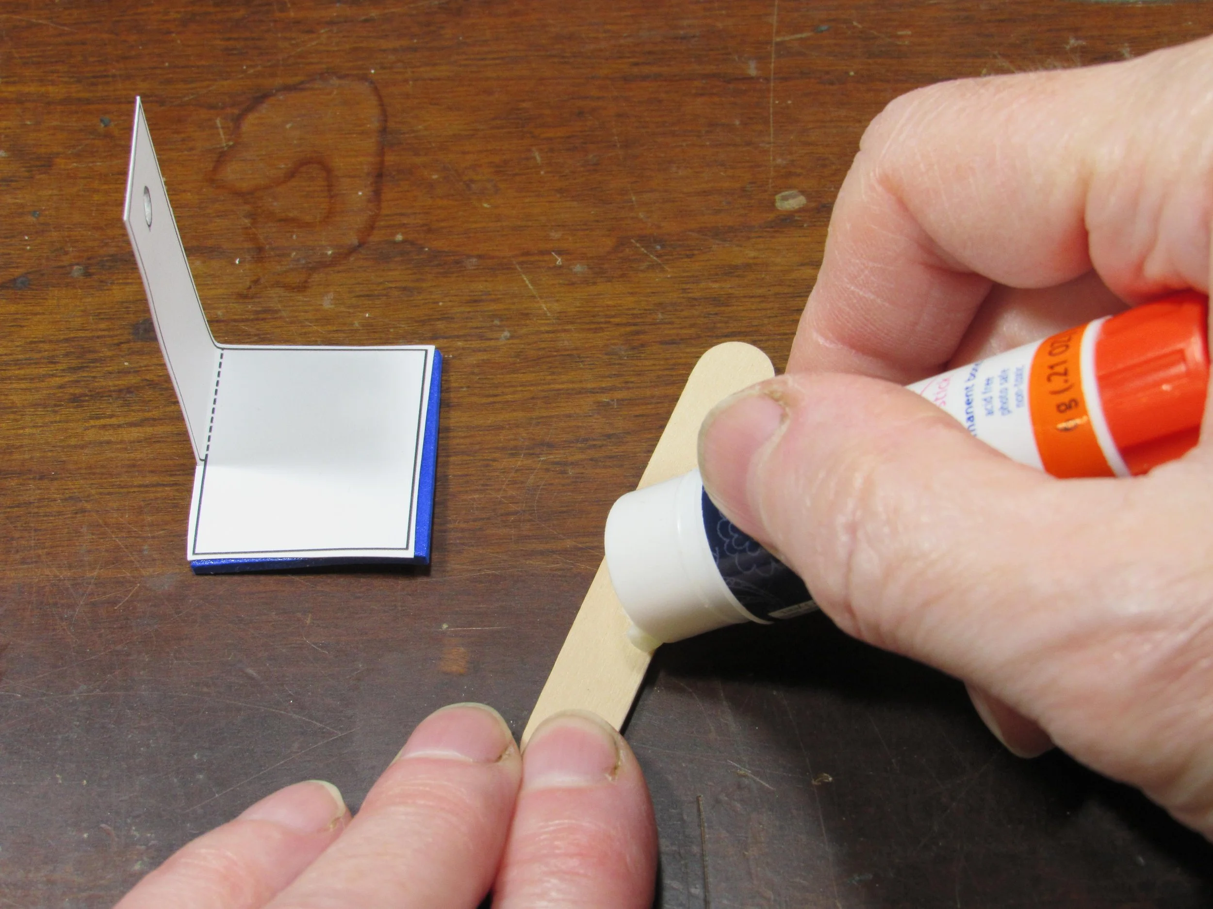 Put glue on a mini craft stick