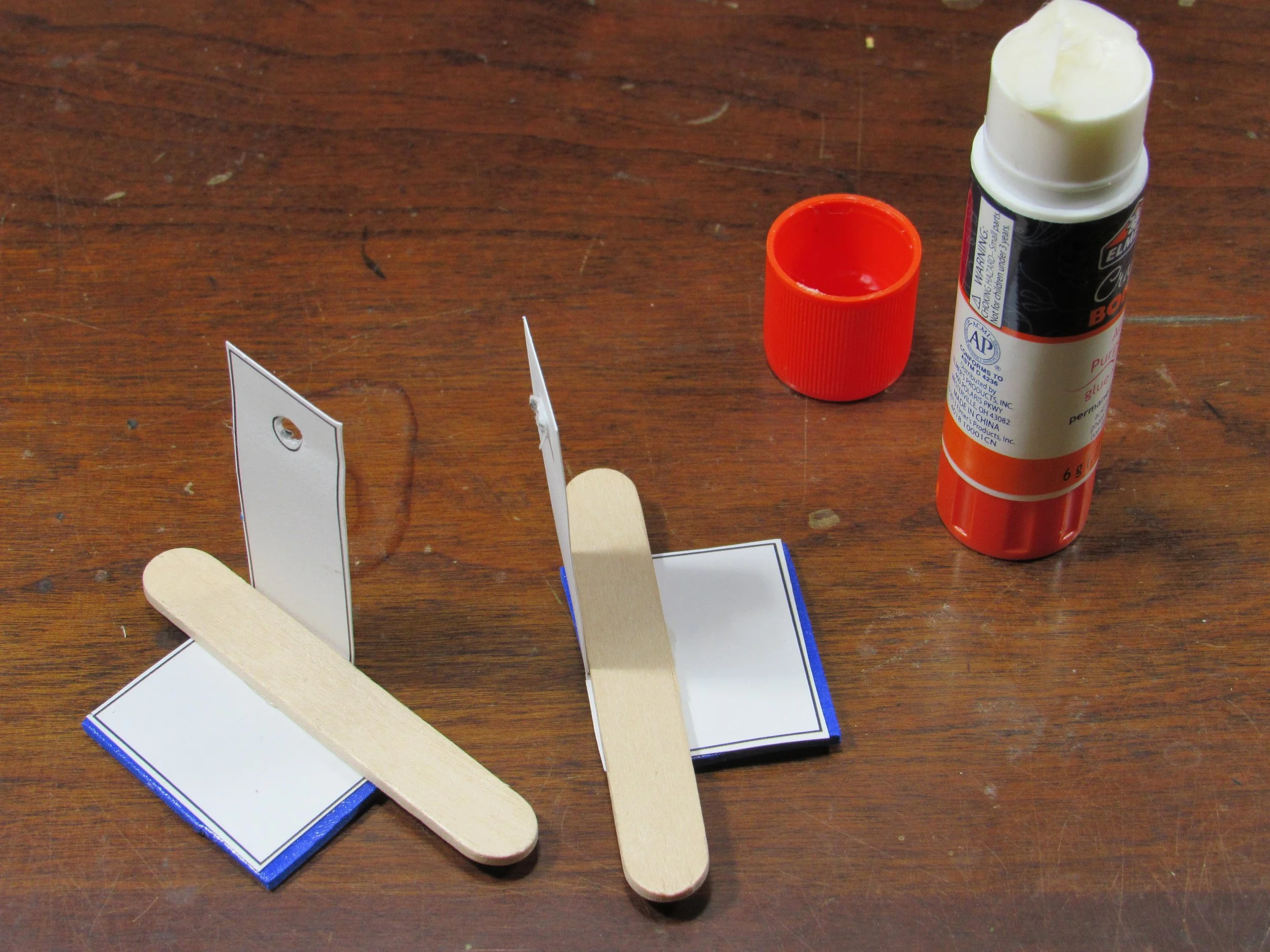 Attach the craft sticks to the feet