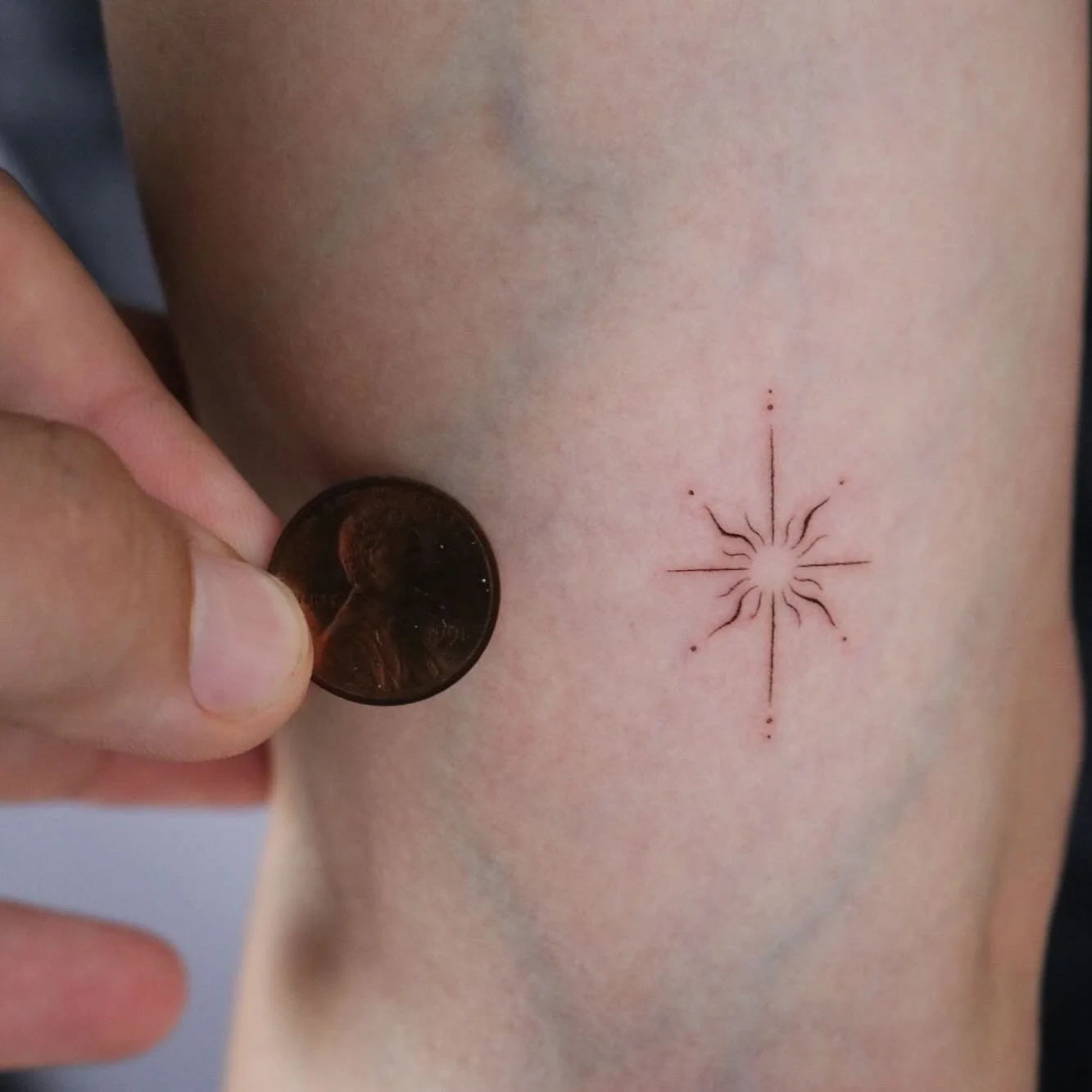 Fine line single needle sun star tattoo design.

Done in San Francisco CA.
