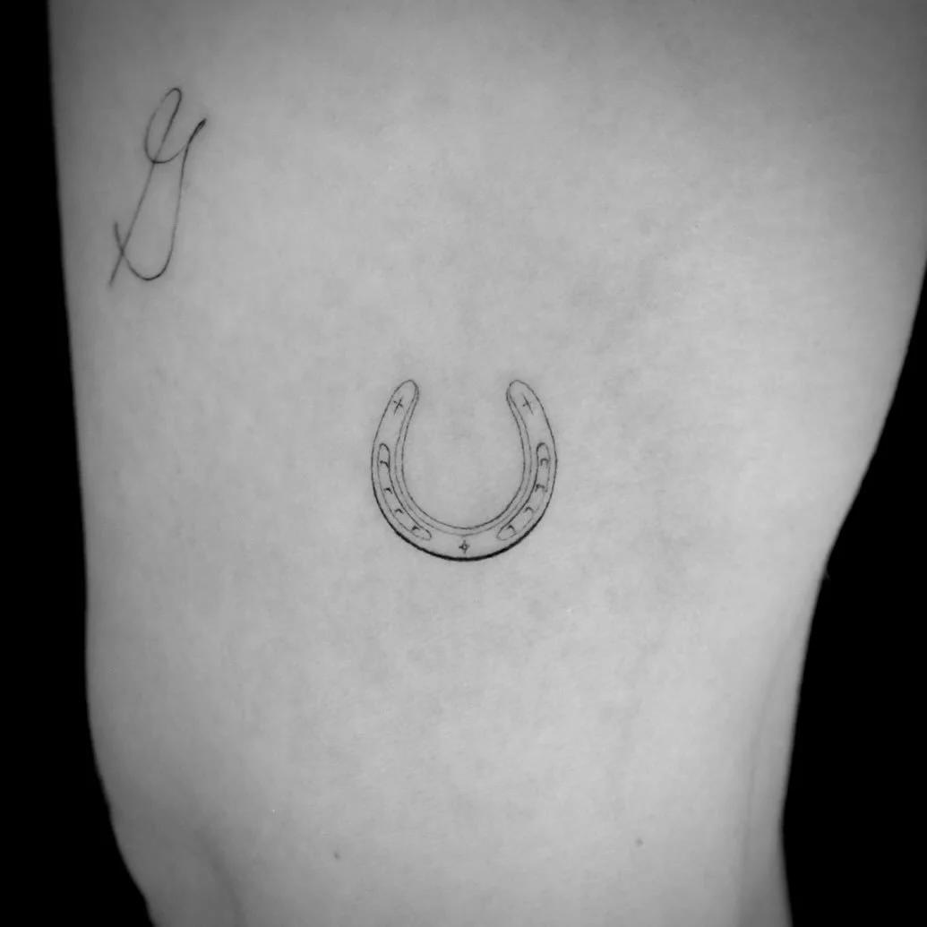 I did this single needle horseshoe and fine line cursive script &ldquo;G&rdquo;. The tattoo design for the calligraphy is of my clients grandmother. The thin dainty horseshoe reminds her of home. Done in San Francisco California.