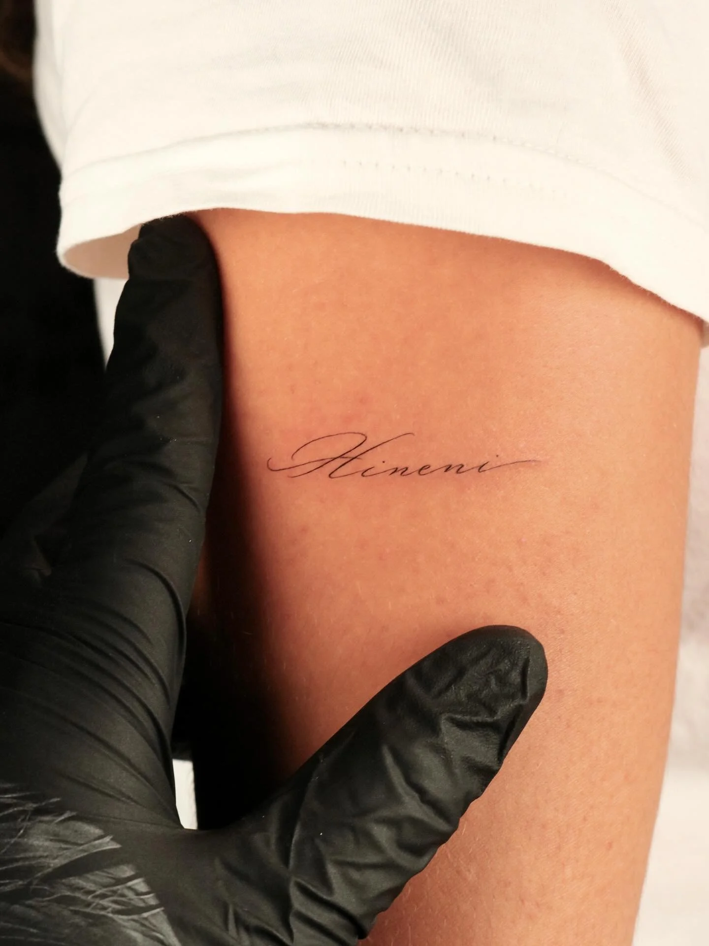 Hineni 

Hebrew for &ldquo;here I am&rdquo;

Signifying total presence, readiness, and availability.

Single needle handwritten cursive tattoo.
&bull;
&bull;
&bull;
&bull;
&bull;
#singleneedle #delicate #dainty  #tattoo #ink #artist #sanfrancisco #ba