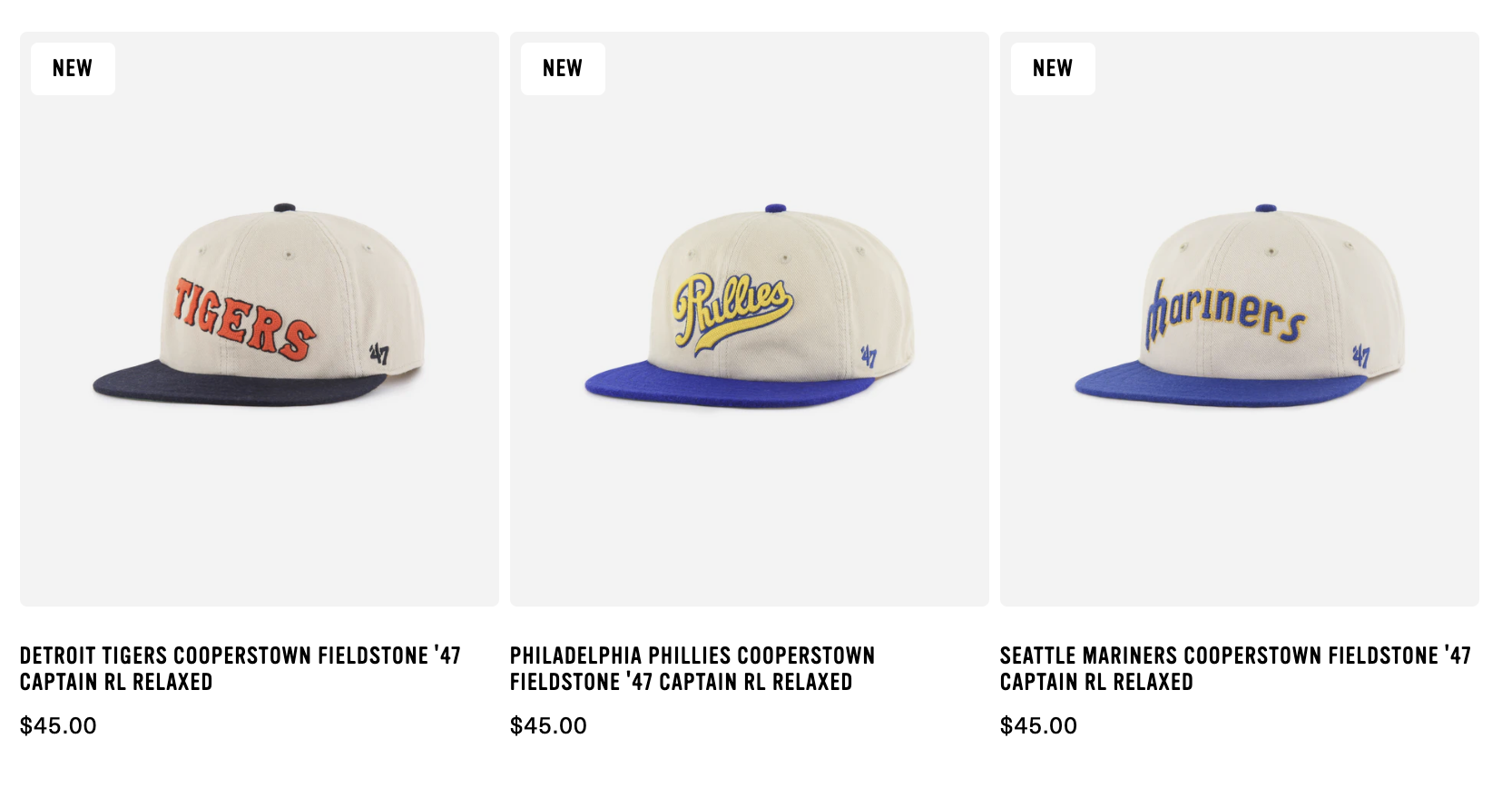 Three vintage-style baseball caps, each with a different sports team logo or name, displayed on a plain background. The first cap features the Detroit Tigers, the second has the Philadelphia Phillies, and the third shows the Seattle Mariners. All caps share a beige crown with contrasting blue brims.