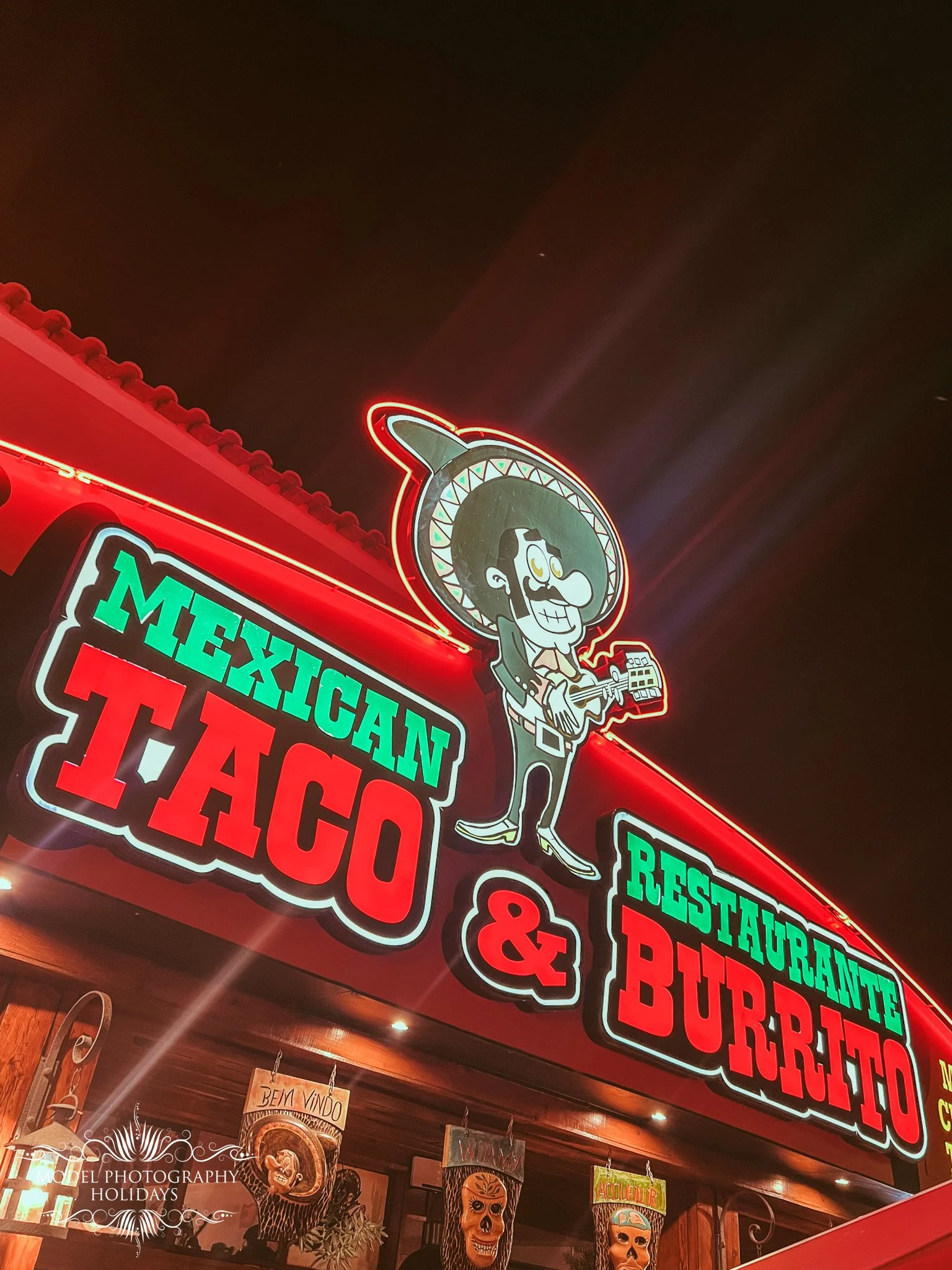 Neon sign for Mexican restaurant, features a cartoon chef with a mustache and sombrero, and text listing Mexican dishes like tacos, burritos, and restaurant details.
