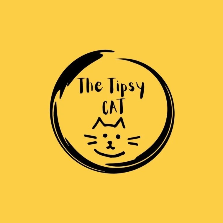 The Tipsy Cat logo - black stylised line drawing of cat's face and text in a rough circle on yellow background