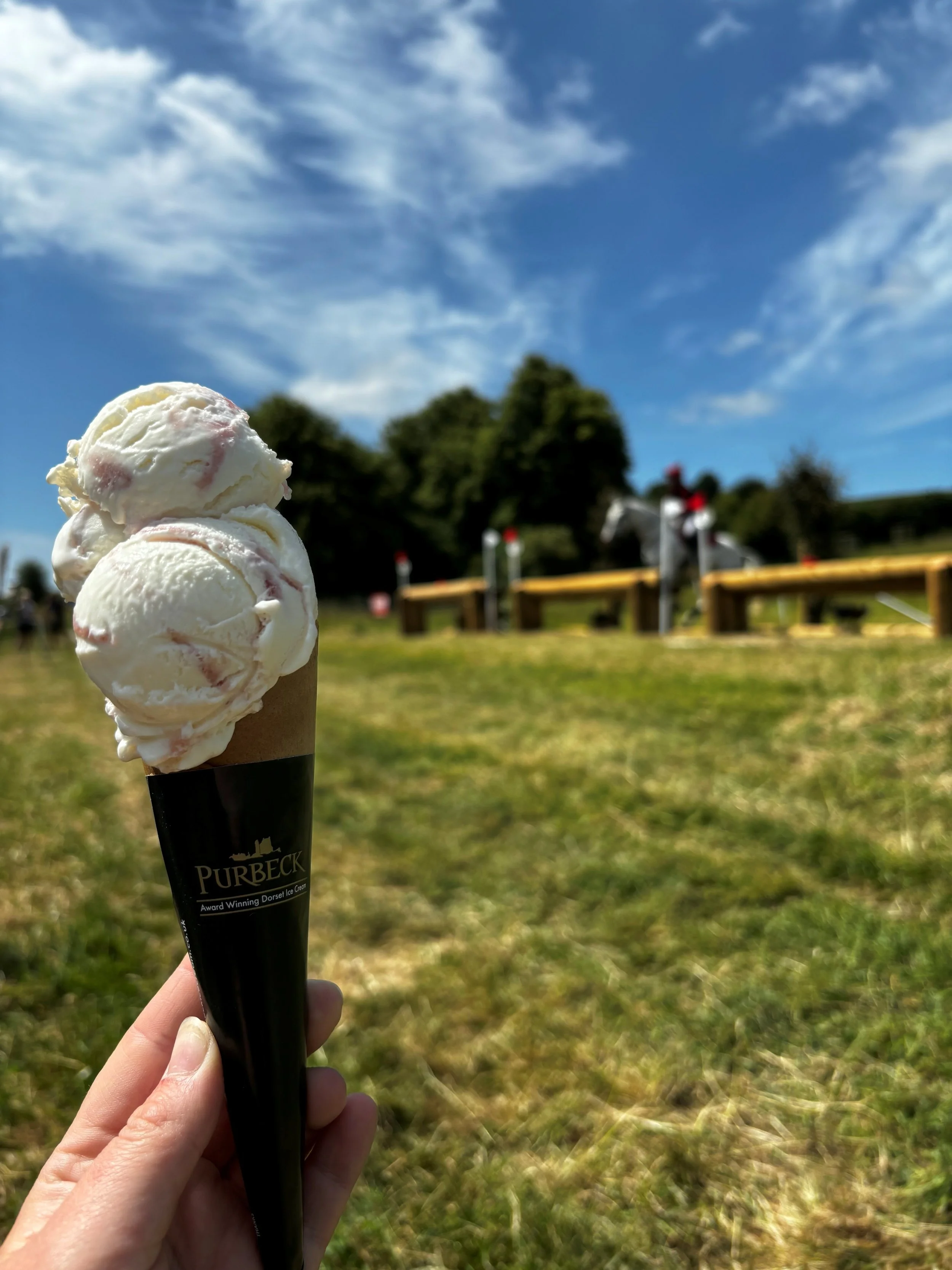 Ice cream cone, with a cross country jump in the background