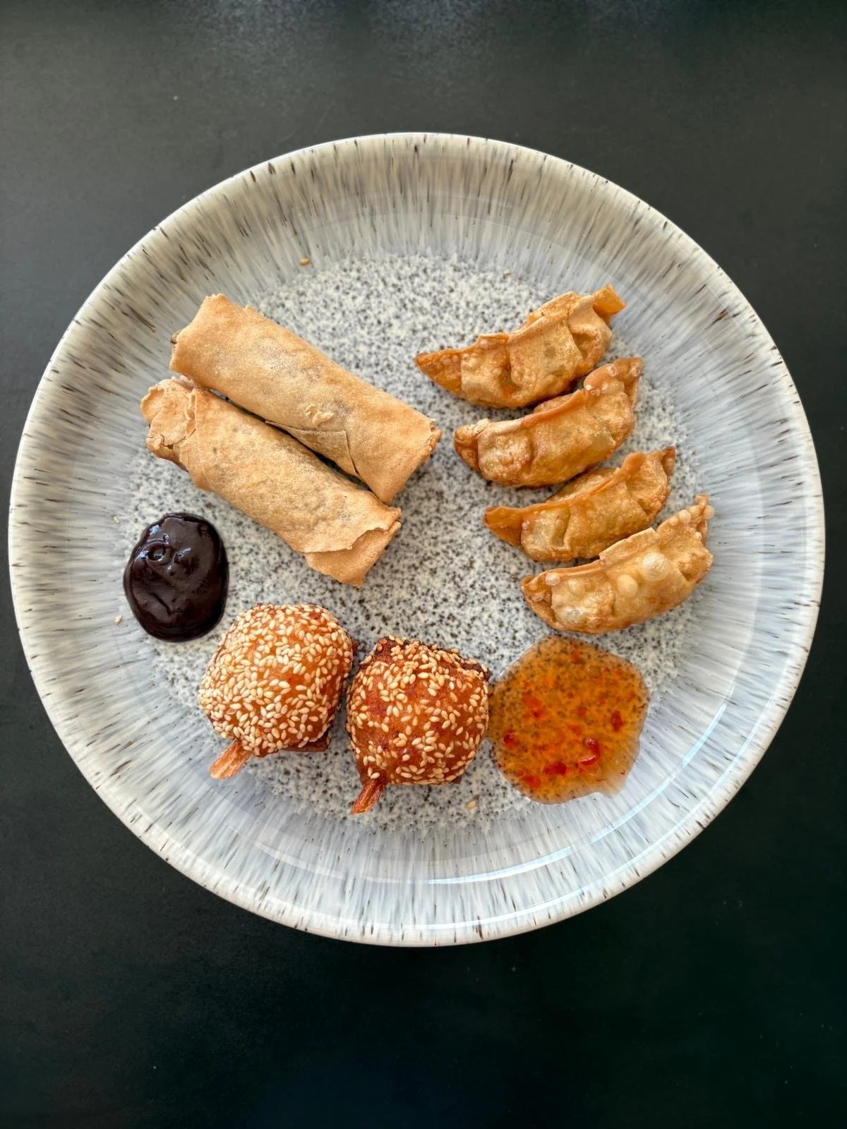 Deep fried combo street food on a stoneware plate