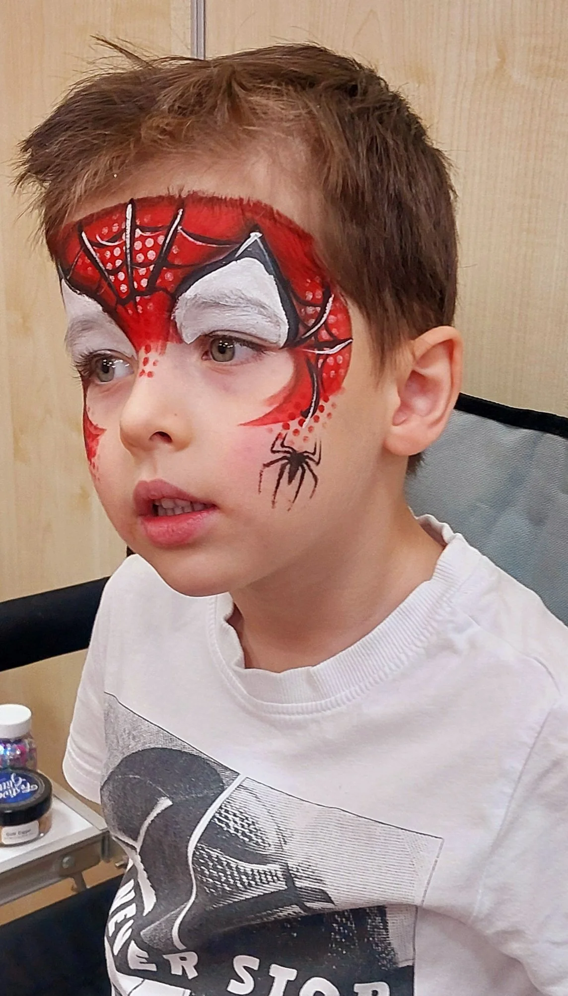 Young boy with Spiderman design face paint