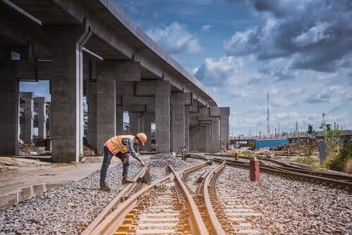 View on a rail track and a tradesman in neon orange workwear. .jpg