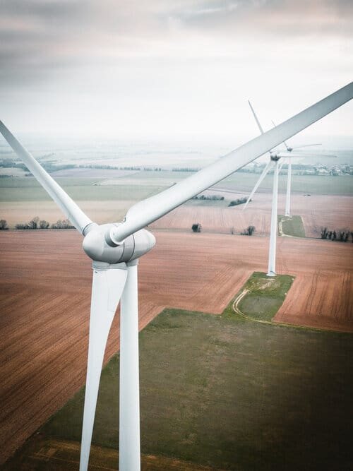 Three wind wheels on a countryside landscape..jpeg