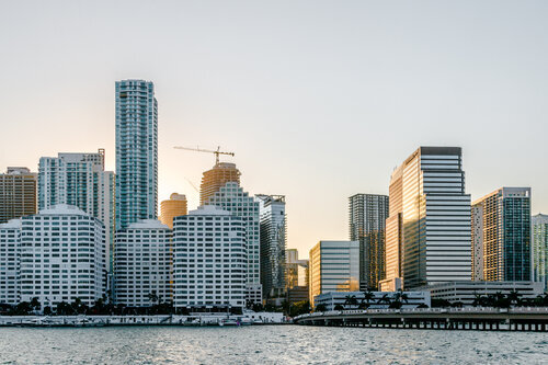 Skyline at sunset with tall buildings bordering on the water..jpeg