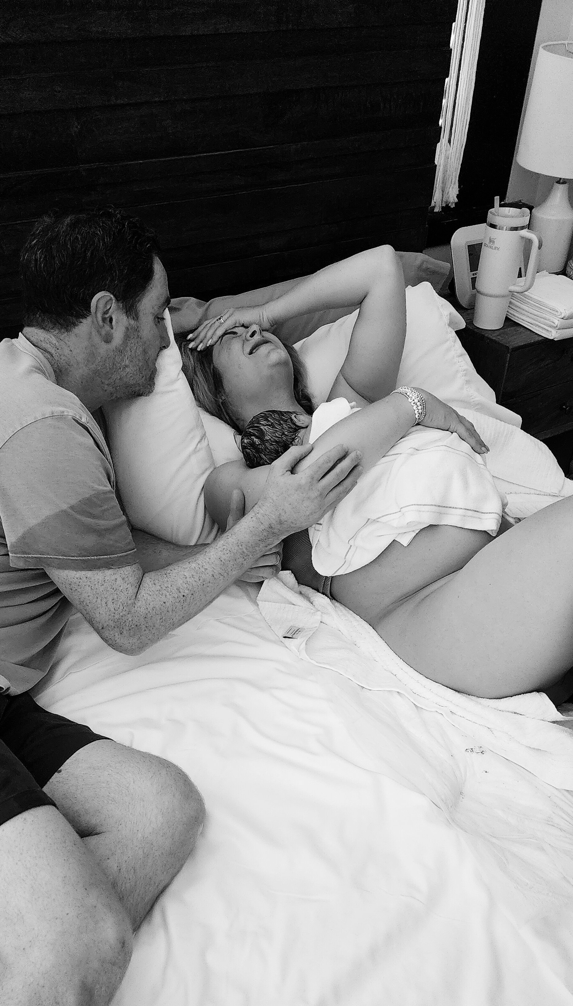 Emotional moment between mom and dad immediately after birth at home.