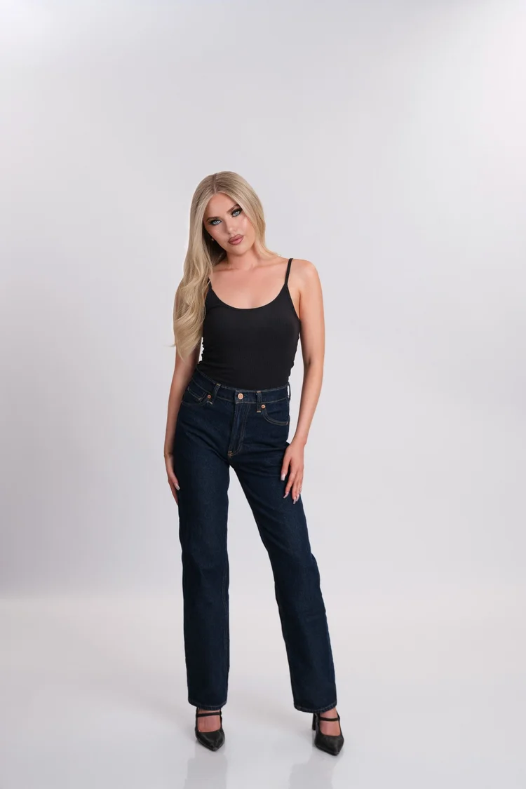Women’s model digital, full-length front view in fitted black basics