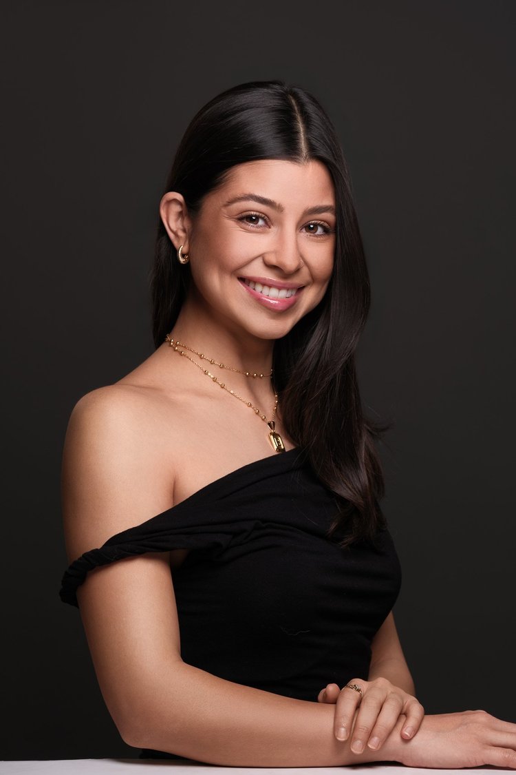 Personal brand portrait of a smiling woman against a dark background