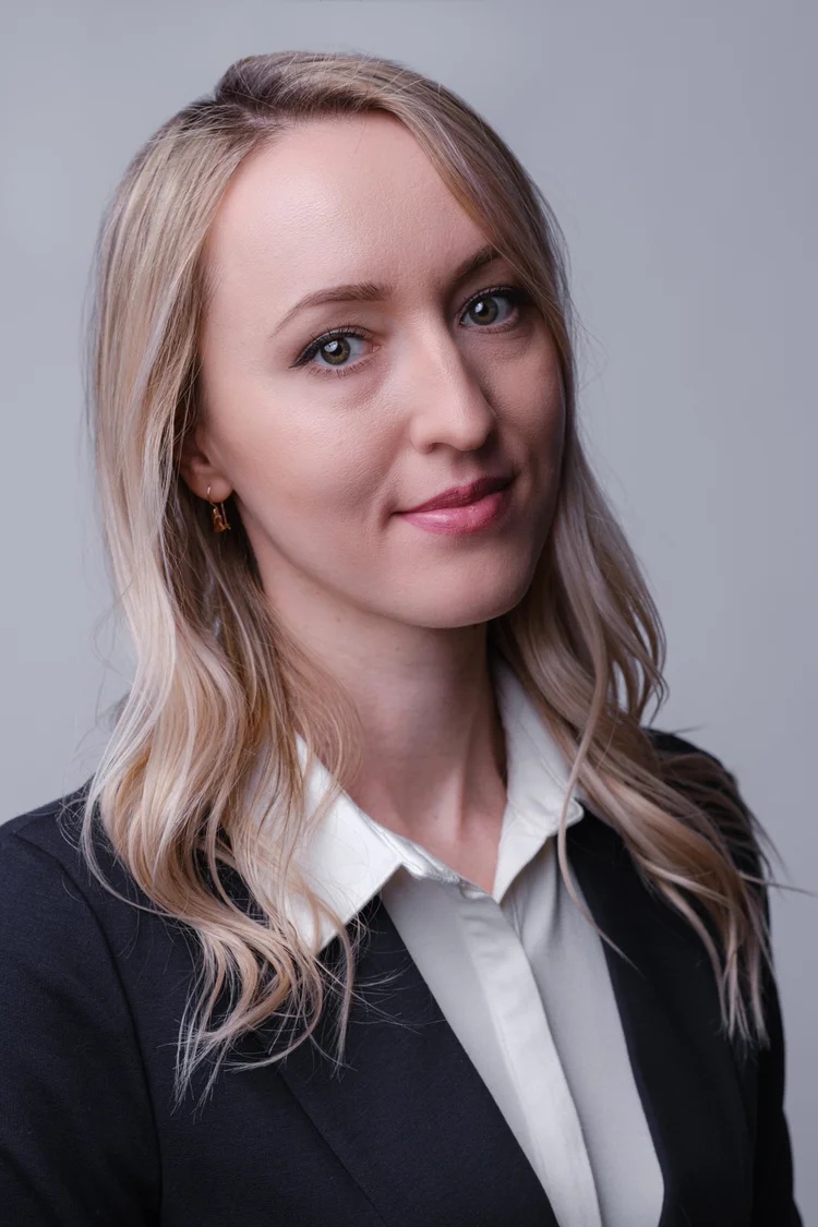 Professional headshot of a woman in a black blazer